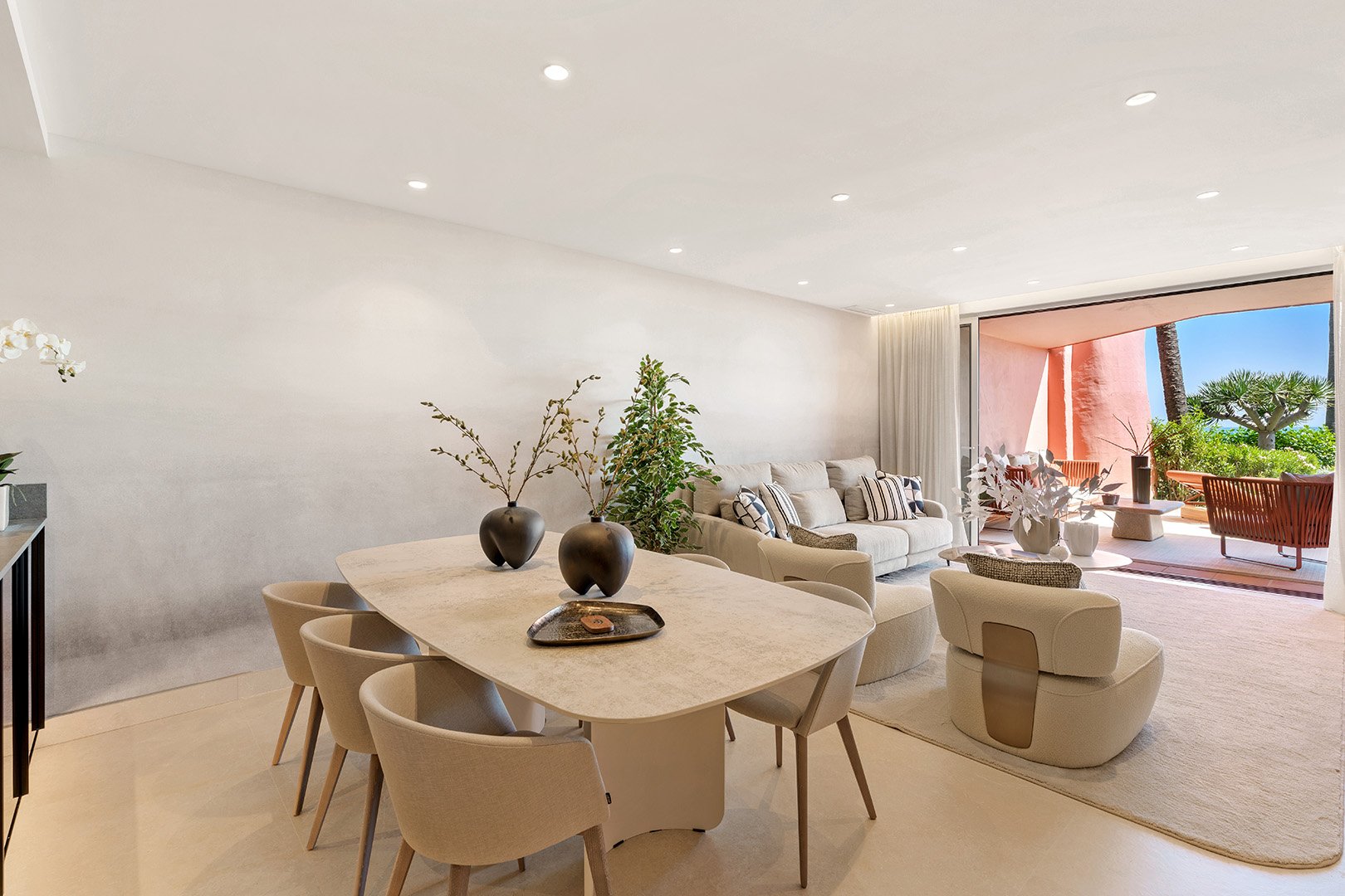Minimalist dining area and gourmet kitchen featuring an island and high-end integrated appliances.