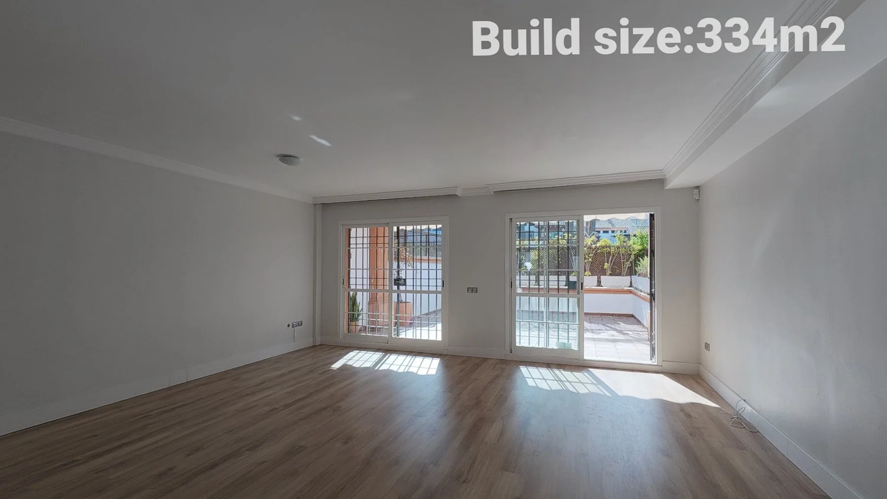 Wide shot showing the lounge area and terrace access.