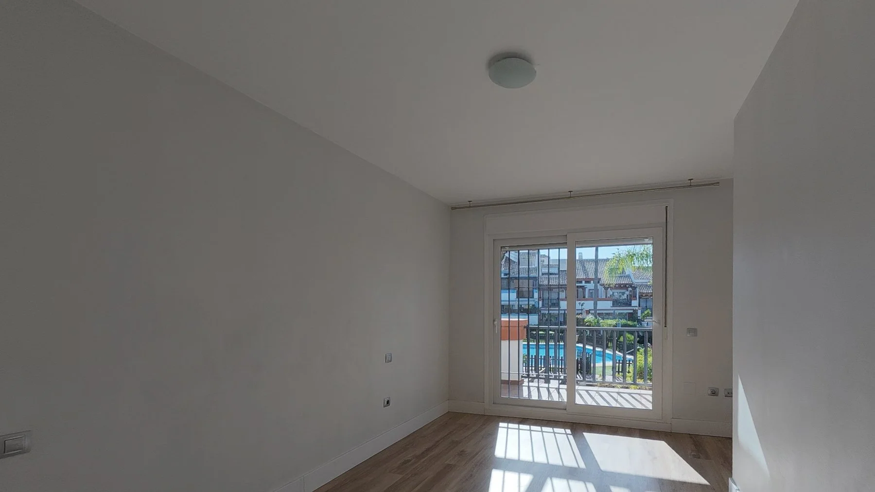 Second Bedroom: Show the fitted wardrobes and clean lines.
