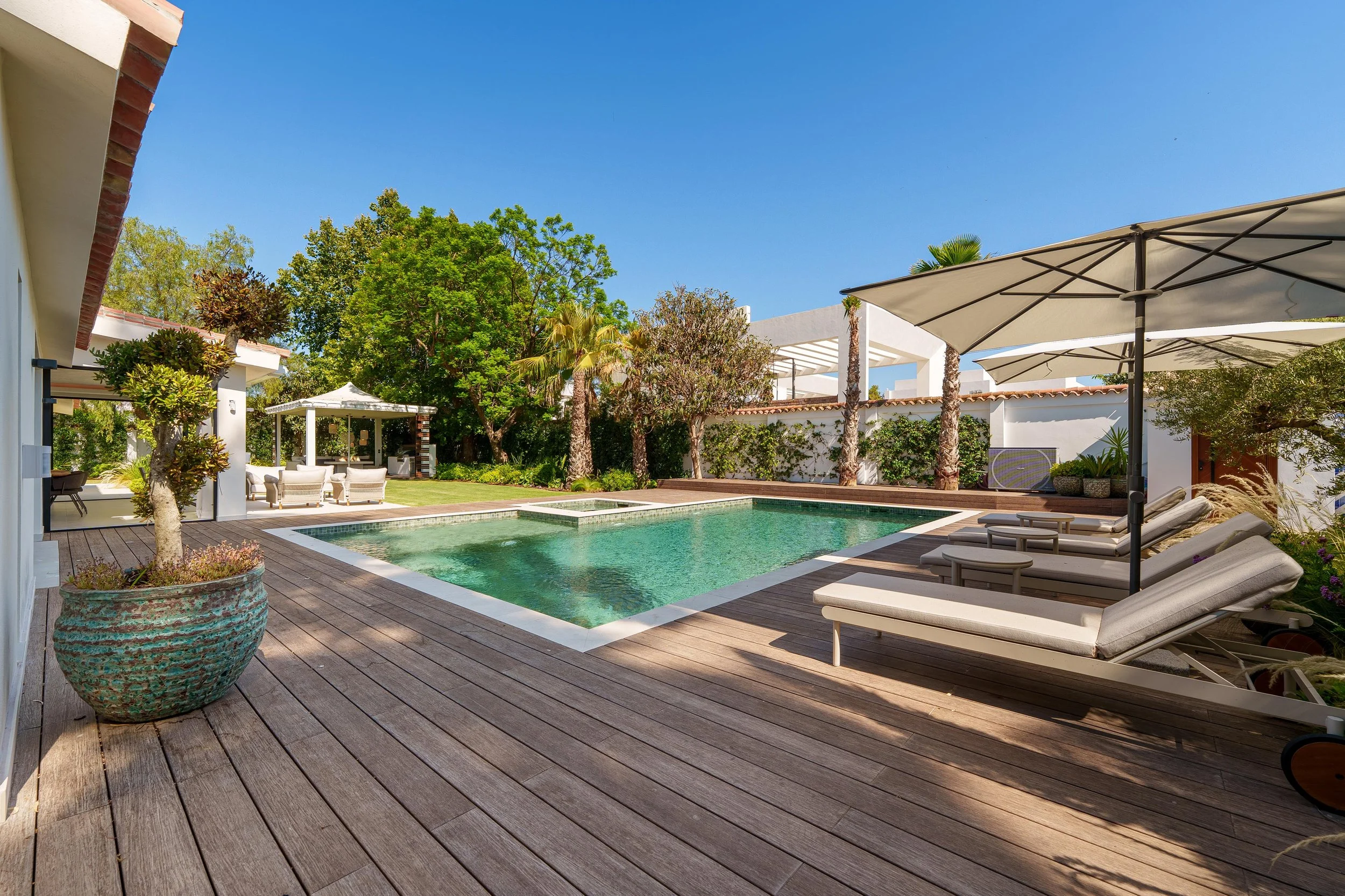 Wide-angle view of the private 1.494 square meter plot with landscaped gardens and large swimming pool.