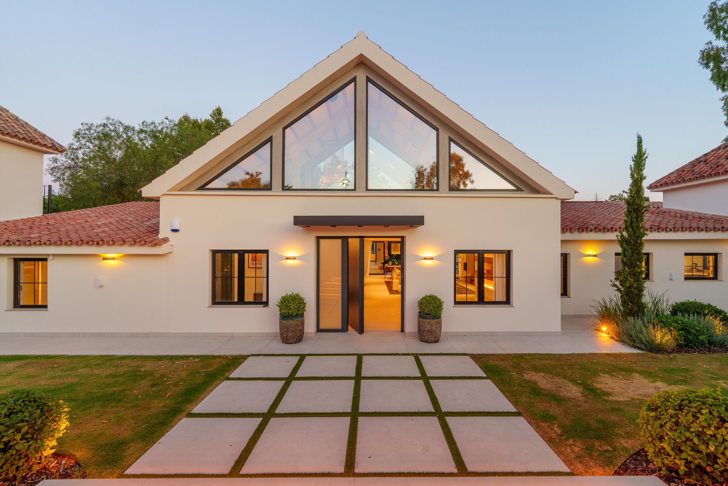 Contemporary villa entrance hall with double-height ceilings and modern minimalist design.