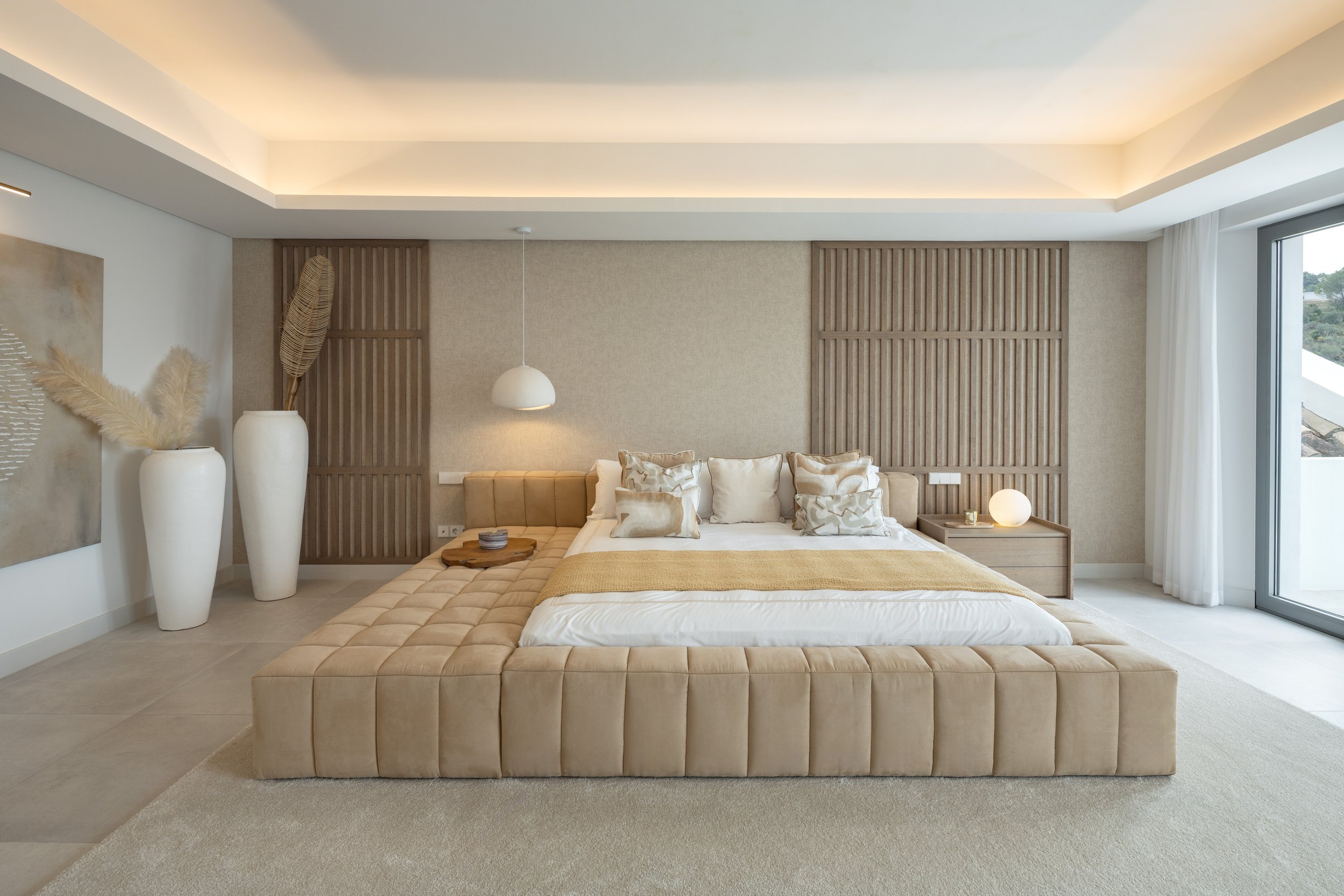 The master suite featuring a minimalist design, warm ambient lighting, and high-end finishes for ultimate relaxation