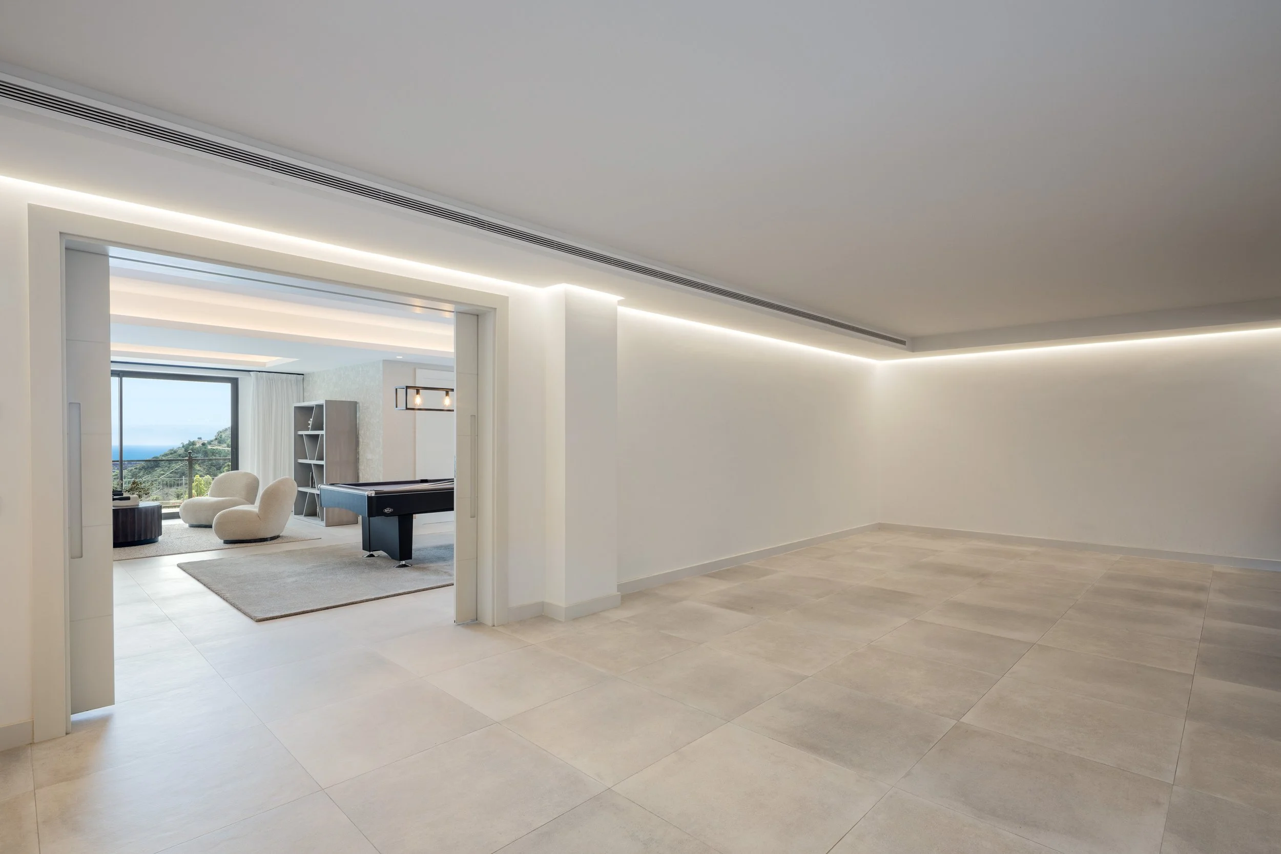 A versatile, large open-plan space on the lower level, ideal for a custom gym or additional entertainment area