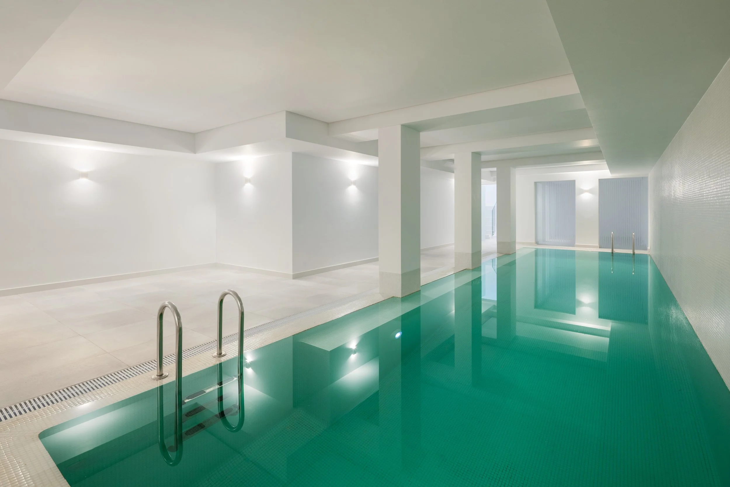 he private wellness center located on the lower floor, featuring a large, heated indoor swimming pool.