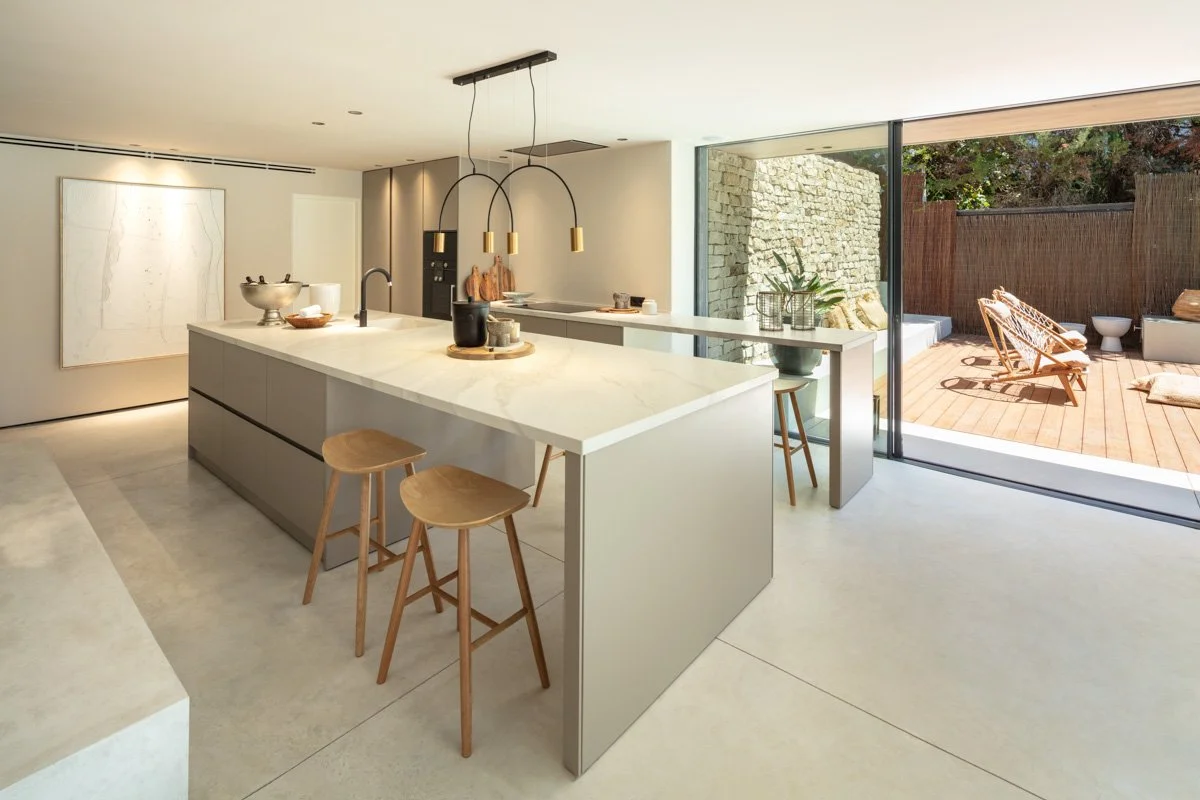 State-of-the-art kitchen with a large minimalist island and integrated professional appliances.