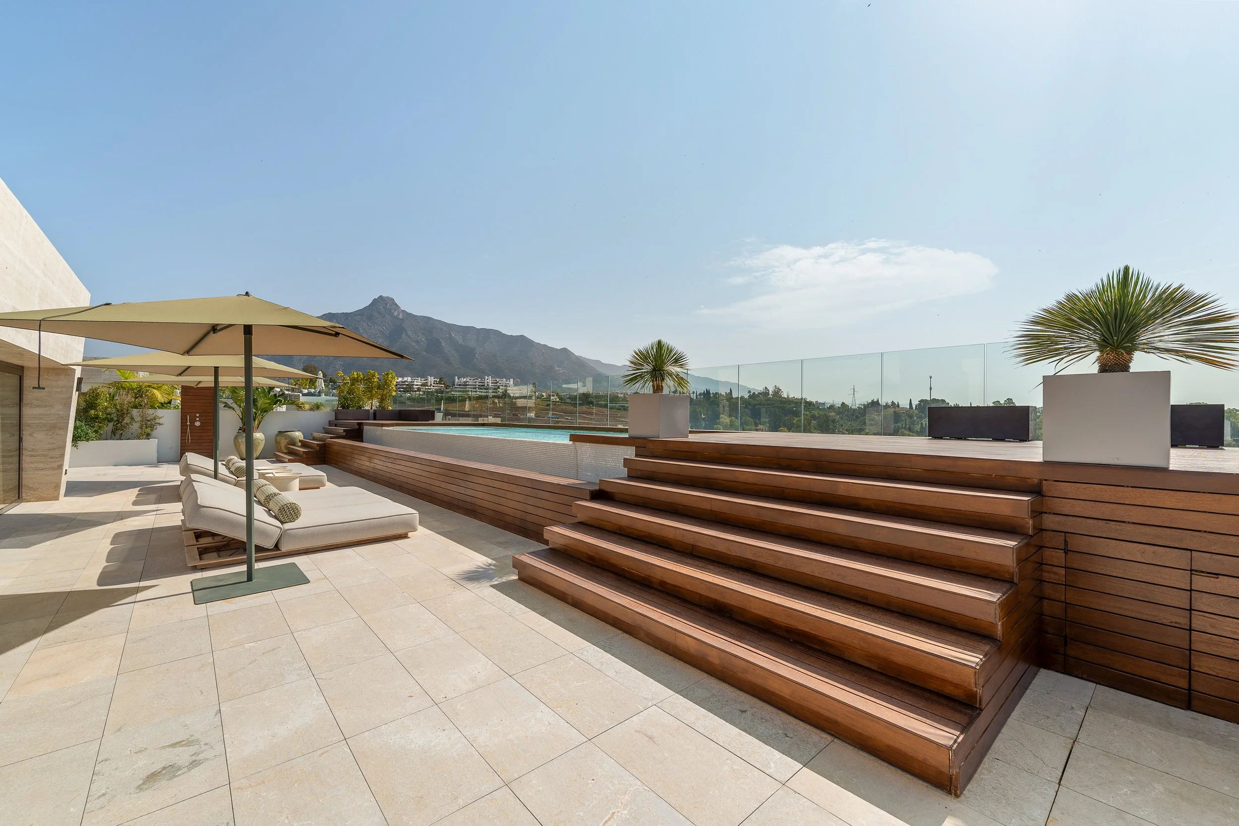 Private infinity-edge swimming pool on a large 536 m² wooden deck solarium