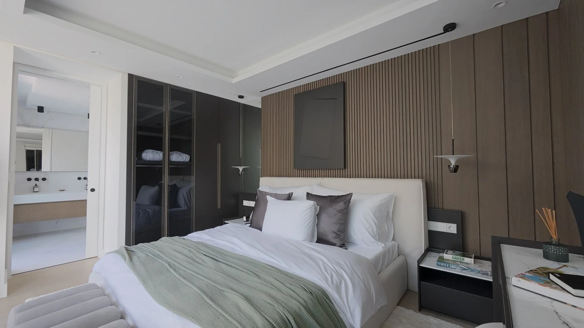 Primary Bedroom Suite: A tour capture of the master suite, featuring warm wood-paneled accents and a layout that prioritizes a private terrace connection.