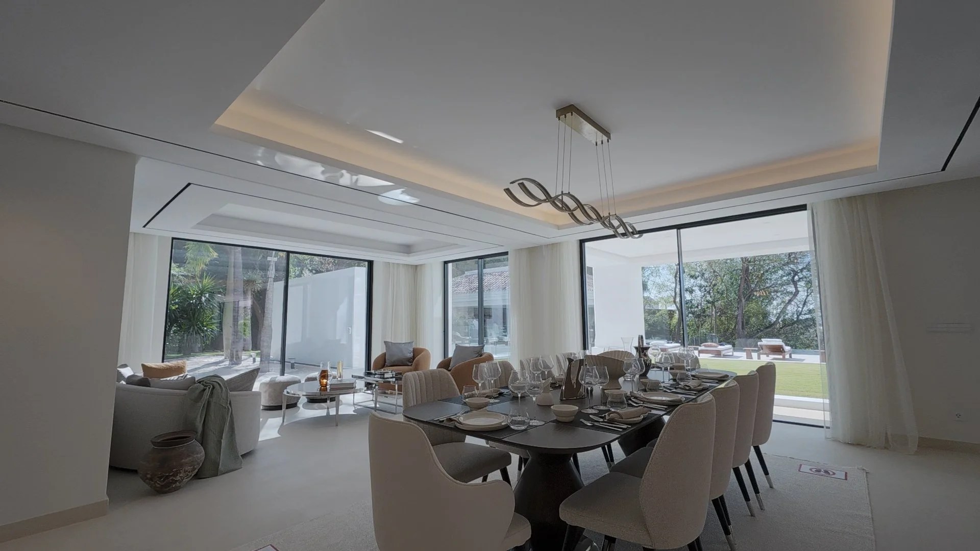 Formal Dining Area: This shot captures the formal dining space, illuminated by designer lighting and surrounded by high-altitude views of La Quinta.