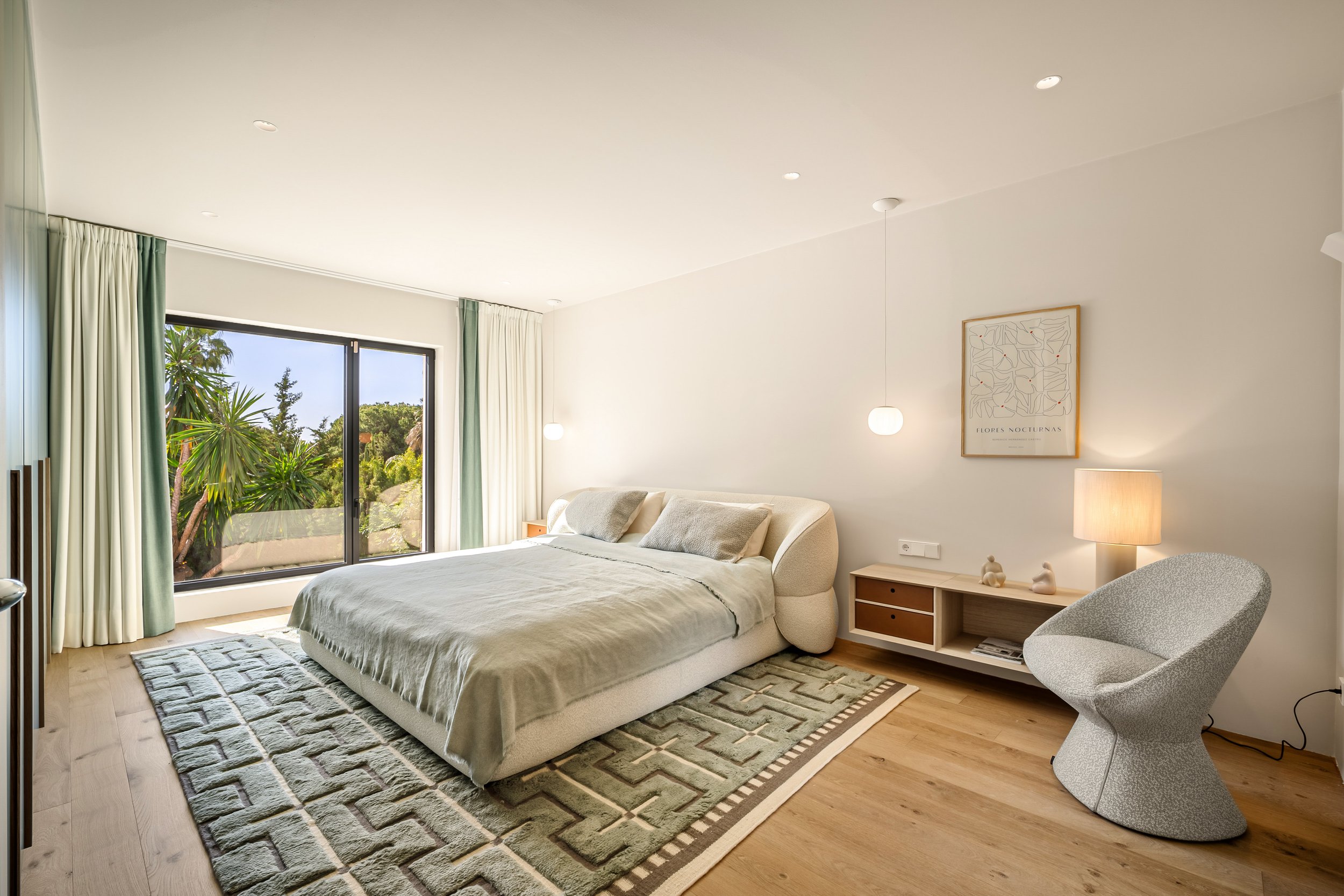 Spacious master bedroom with floor-to-ceiling windows and contemporary minimalist design