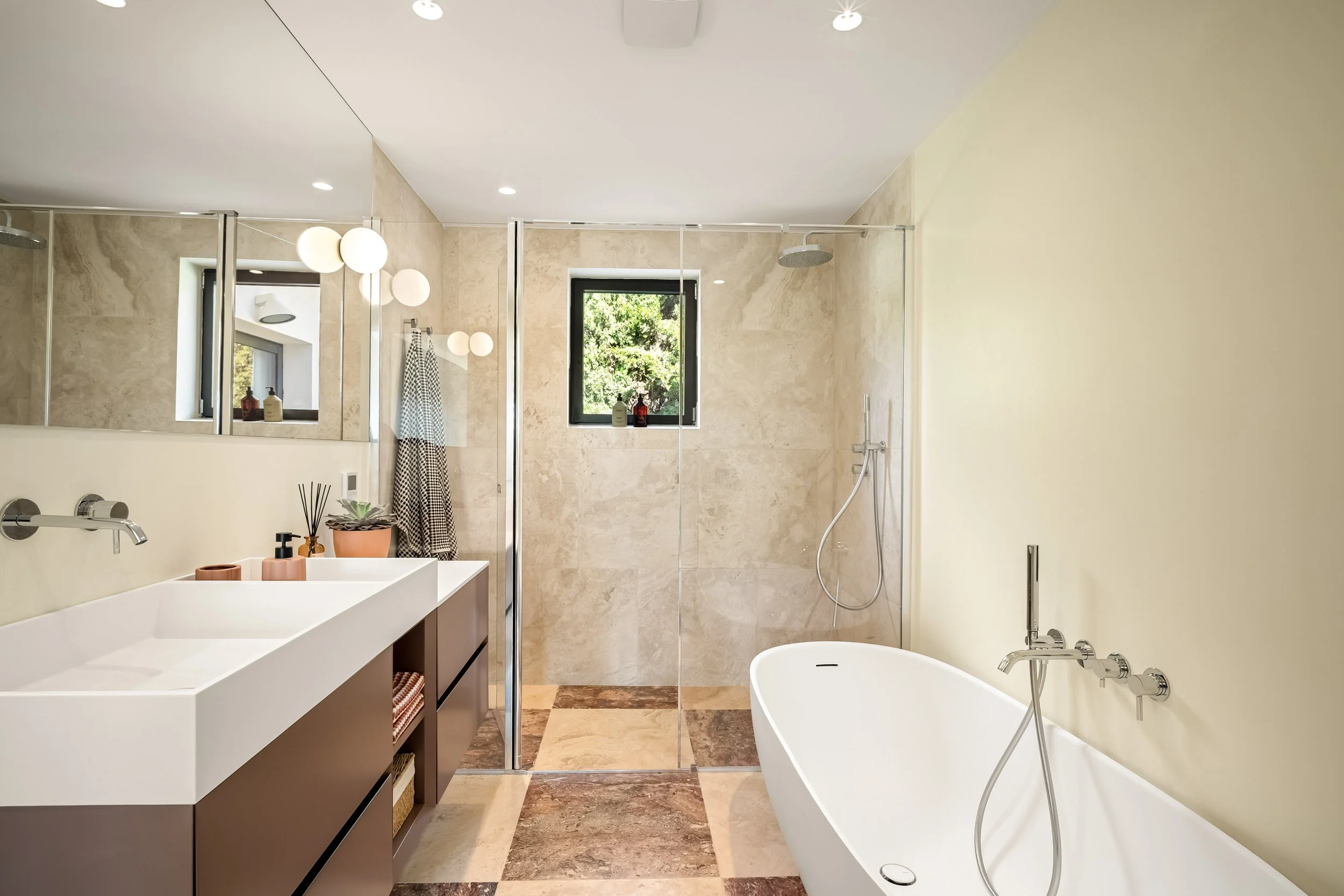 Modern bathroom featuring a freestanding soaking tub and high-quality stone finishes.