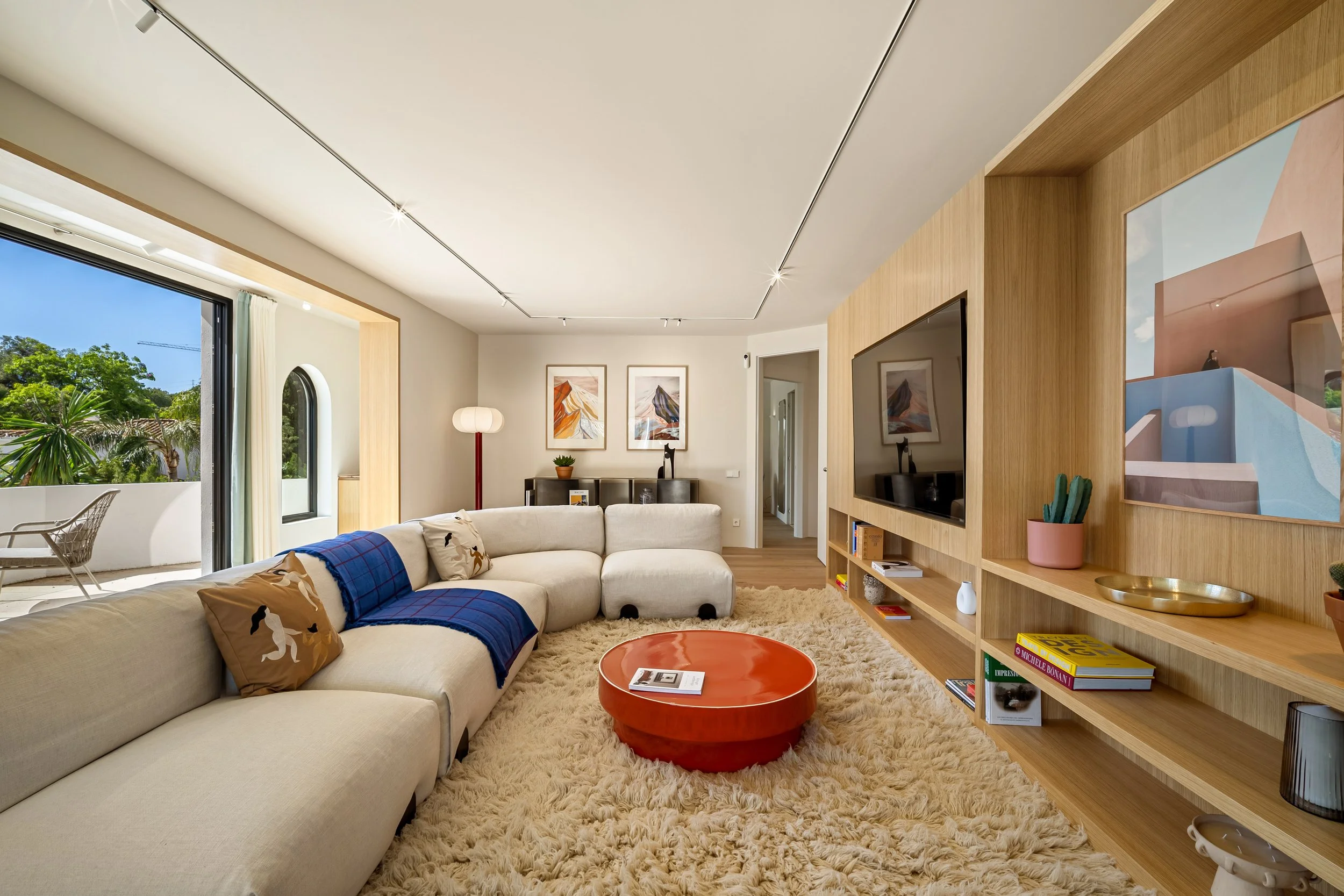 Sophisticated lounge area with plush seating, modern lighting, and garden views
