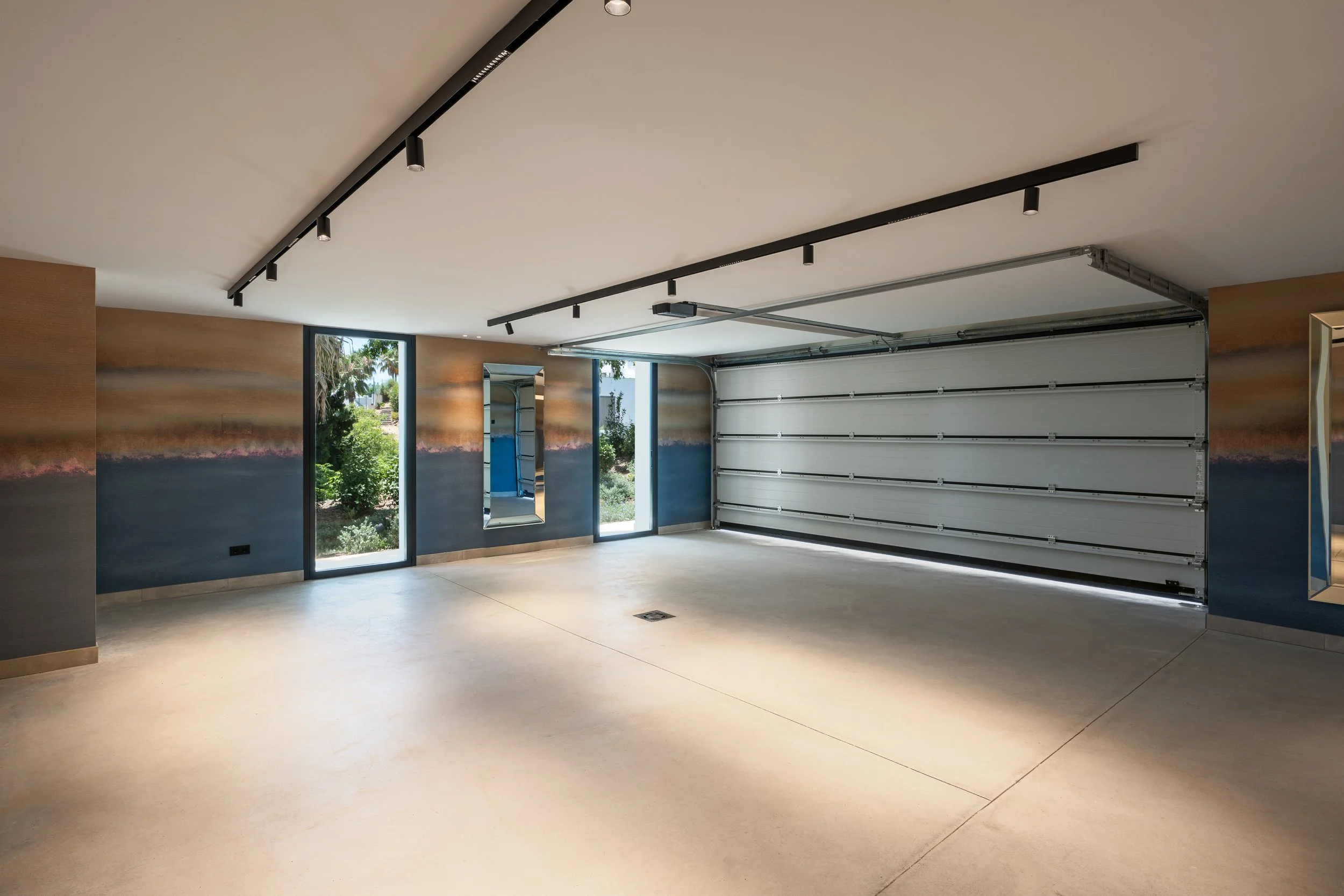 Large private multi-car garage with modern lighting and high-end finish.