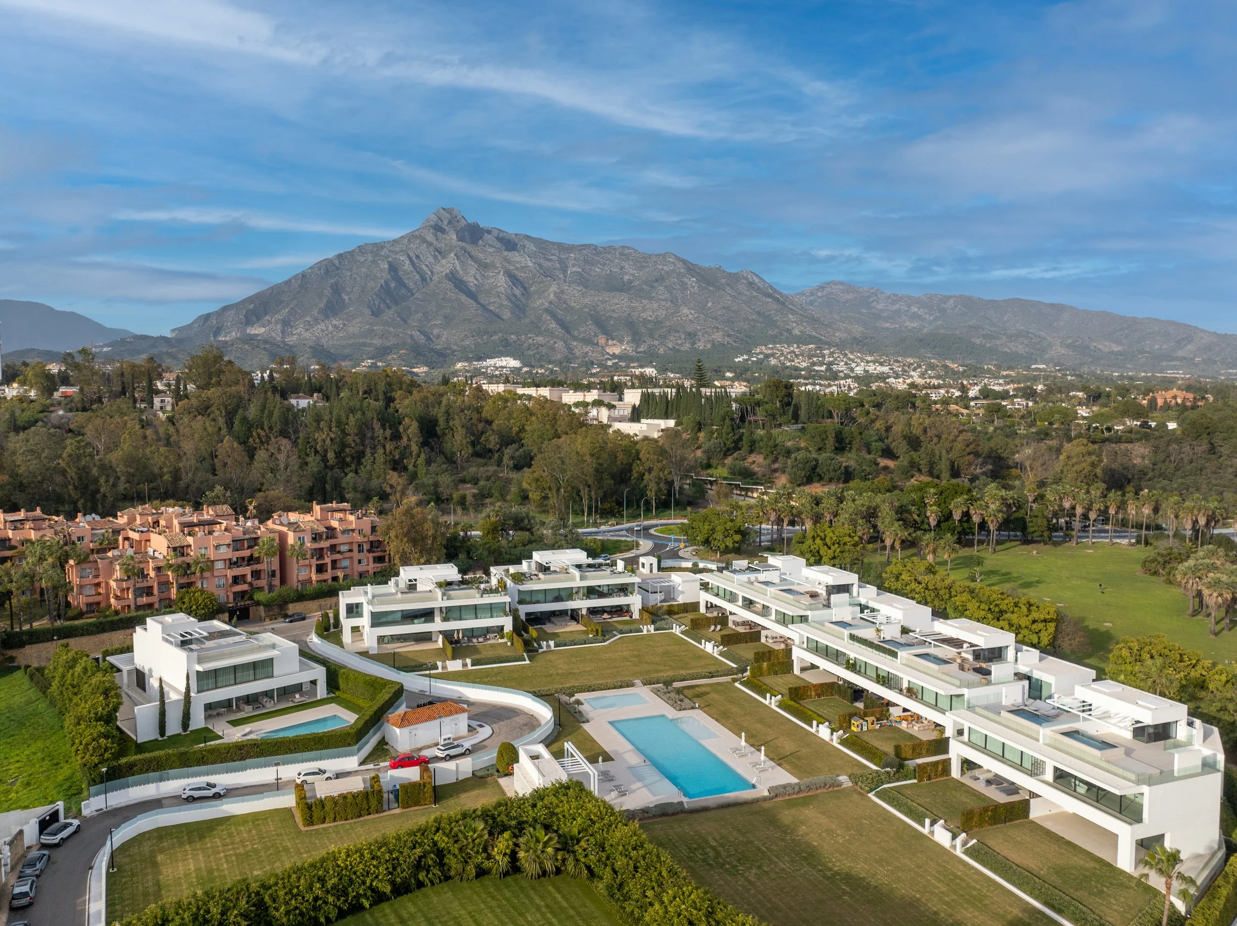 Aerial view of a luxury modern villa complex on the Marbella Golden Mile with La Concha mountain in the background