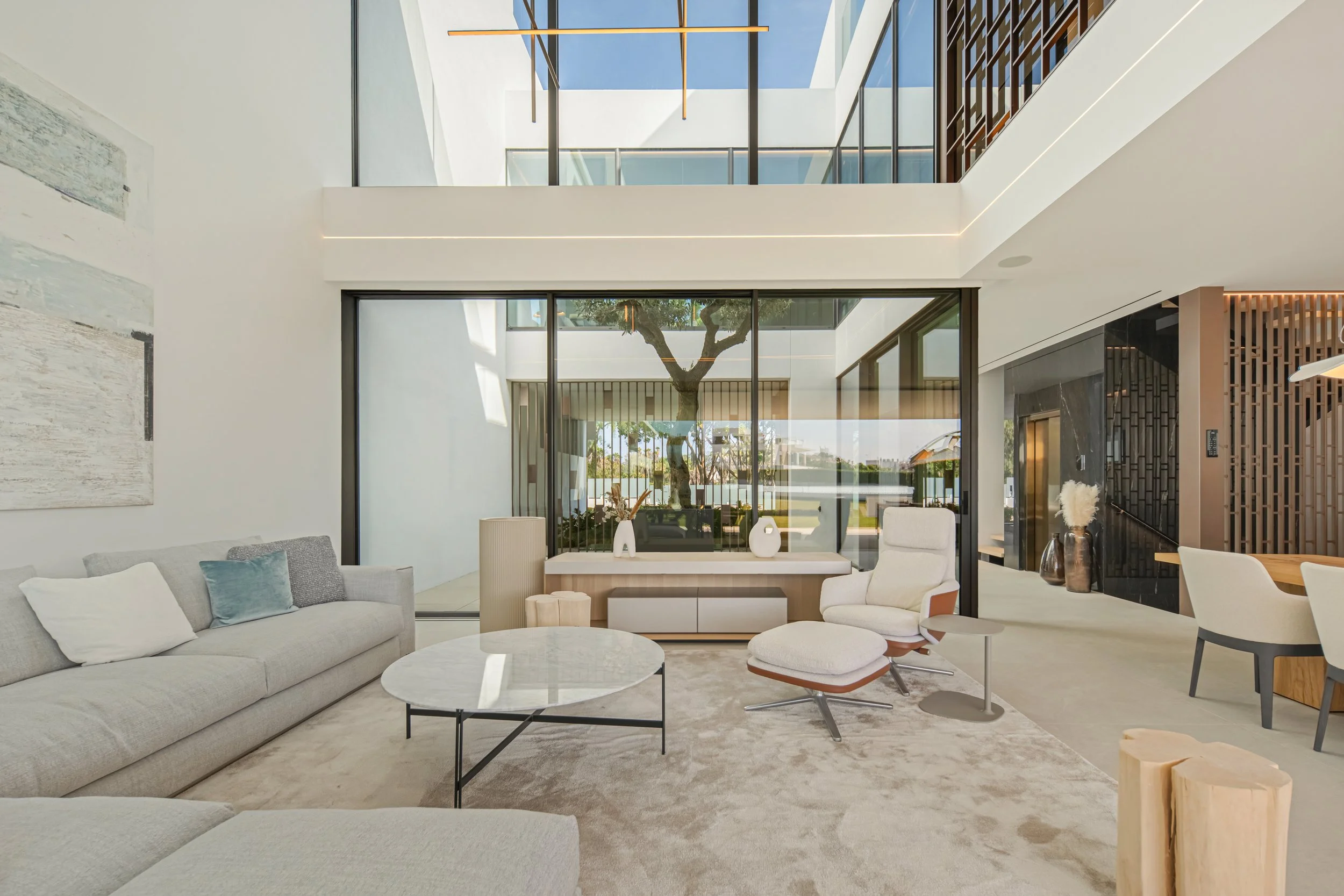 Wide-angle view of the living and dining areas, demonstrating the open flow ideal for luxury family living.