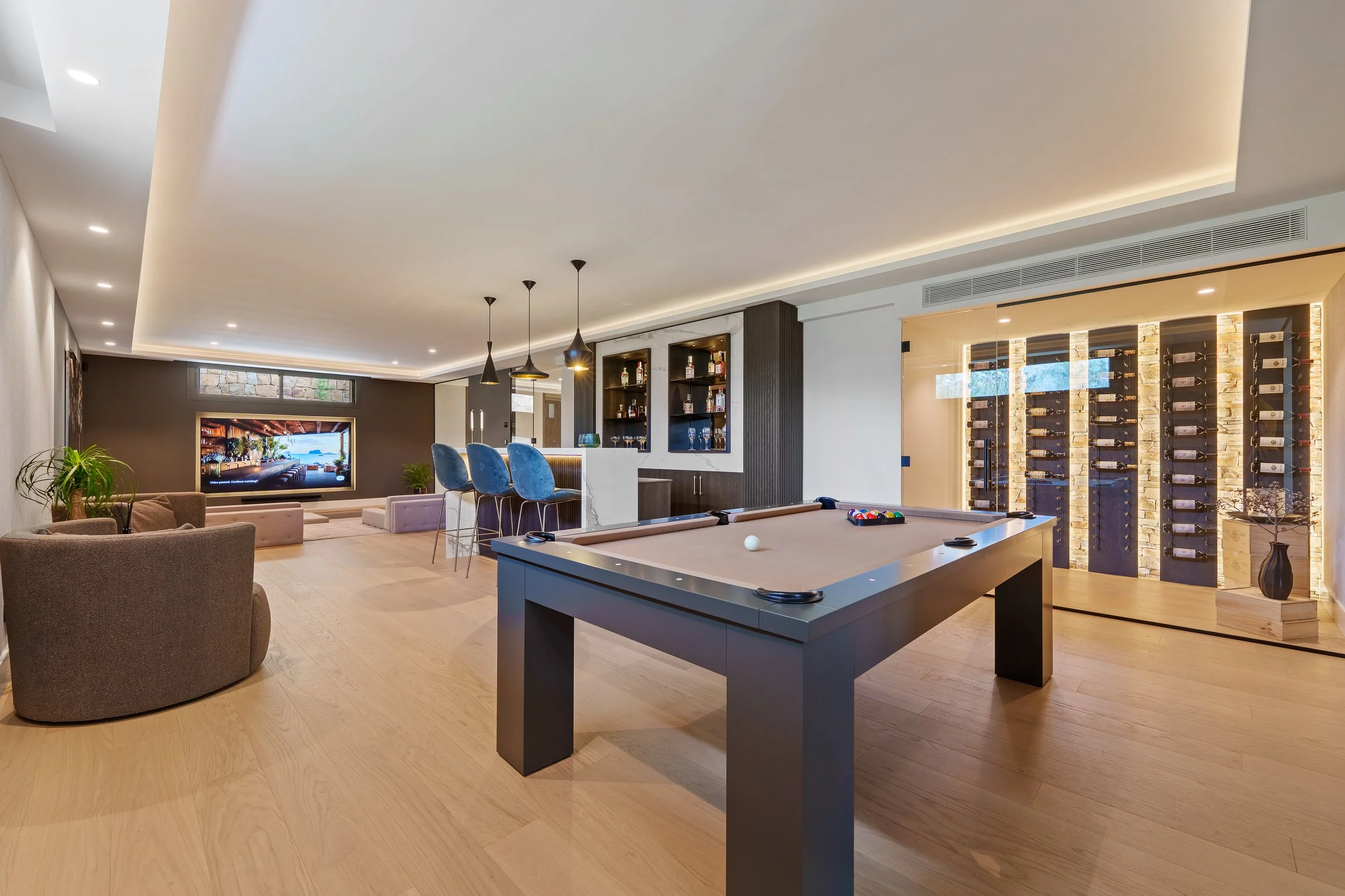 Private entertainment level featuring a professional pool table and wine cellar.