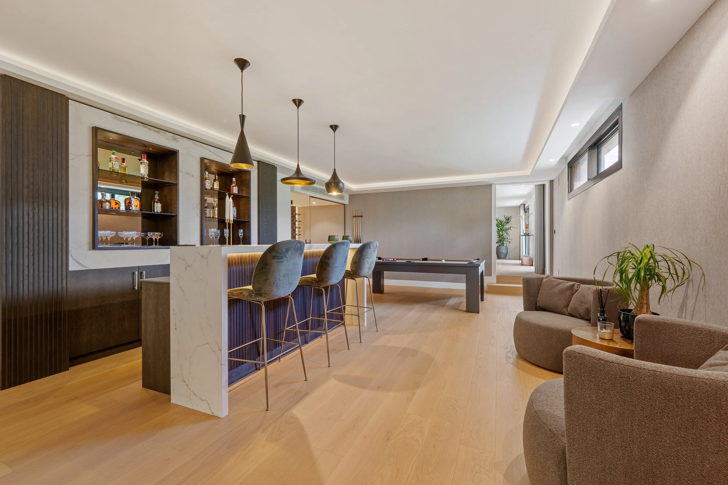 Custom-built indoor bar and social lounge area for high-end entertaining.