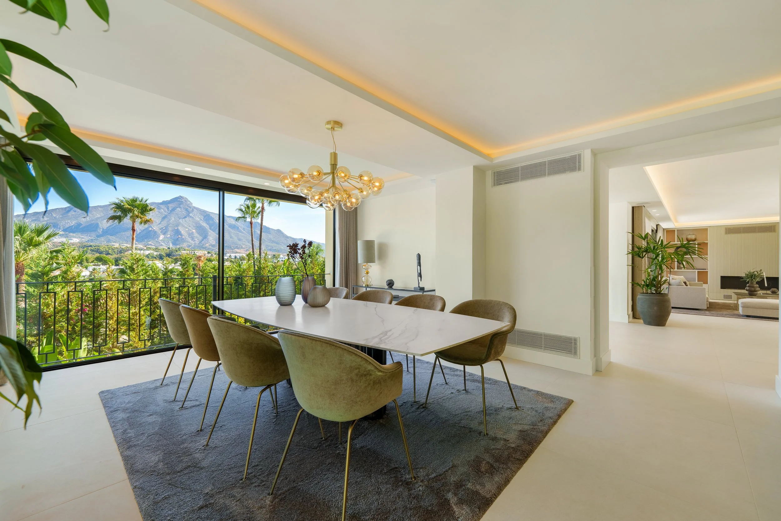 Bright dining space seamlessly connecting the interior to the manicured grounds