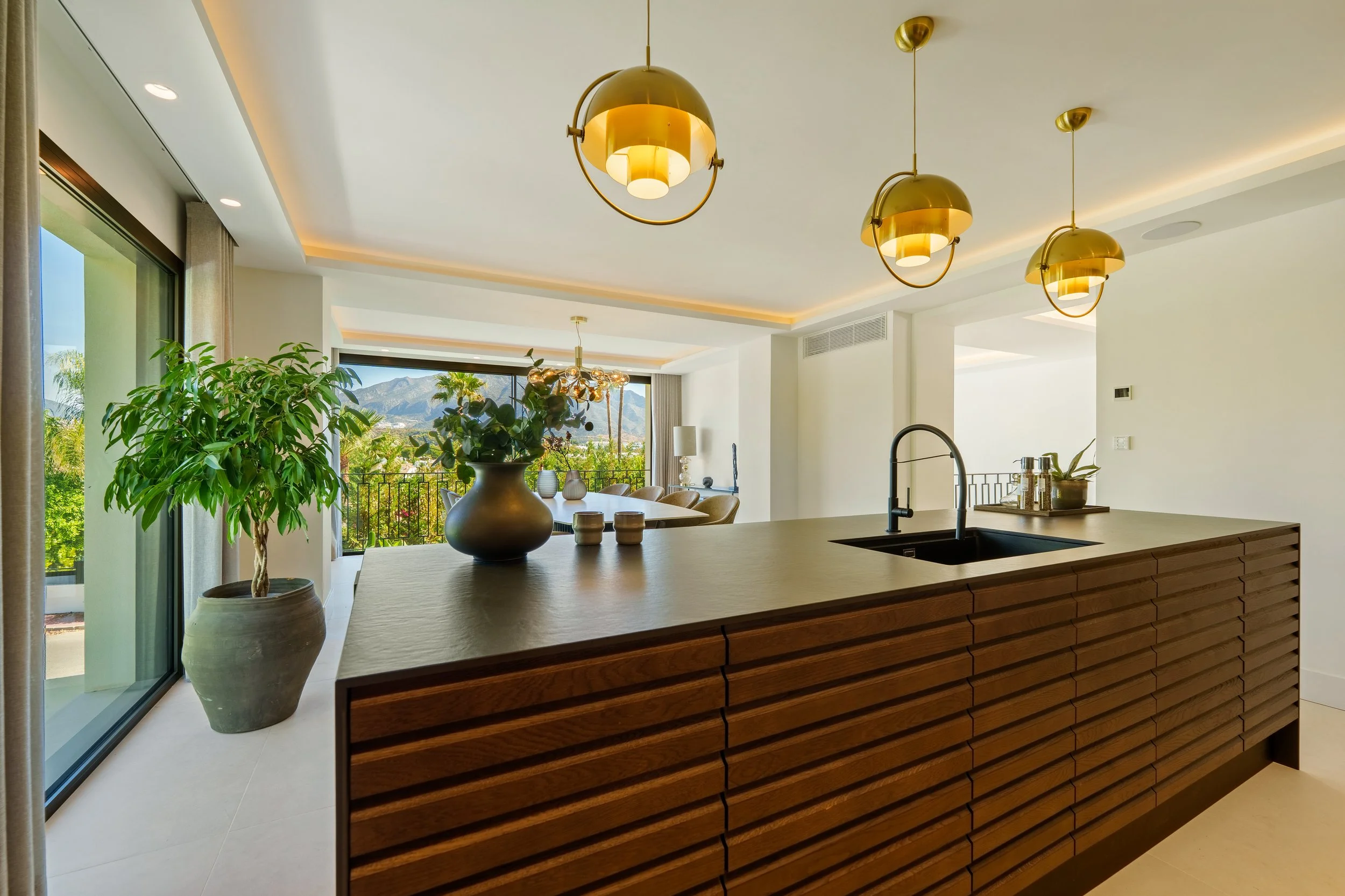 Elegant dining area with modern art and direct access to the garden terrace.