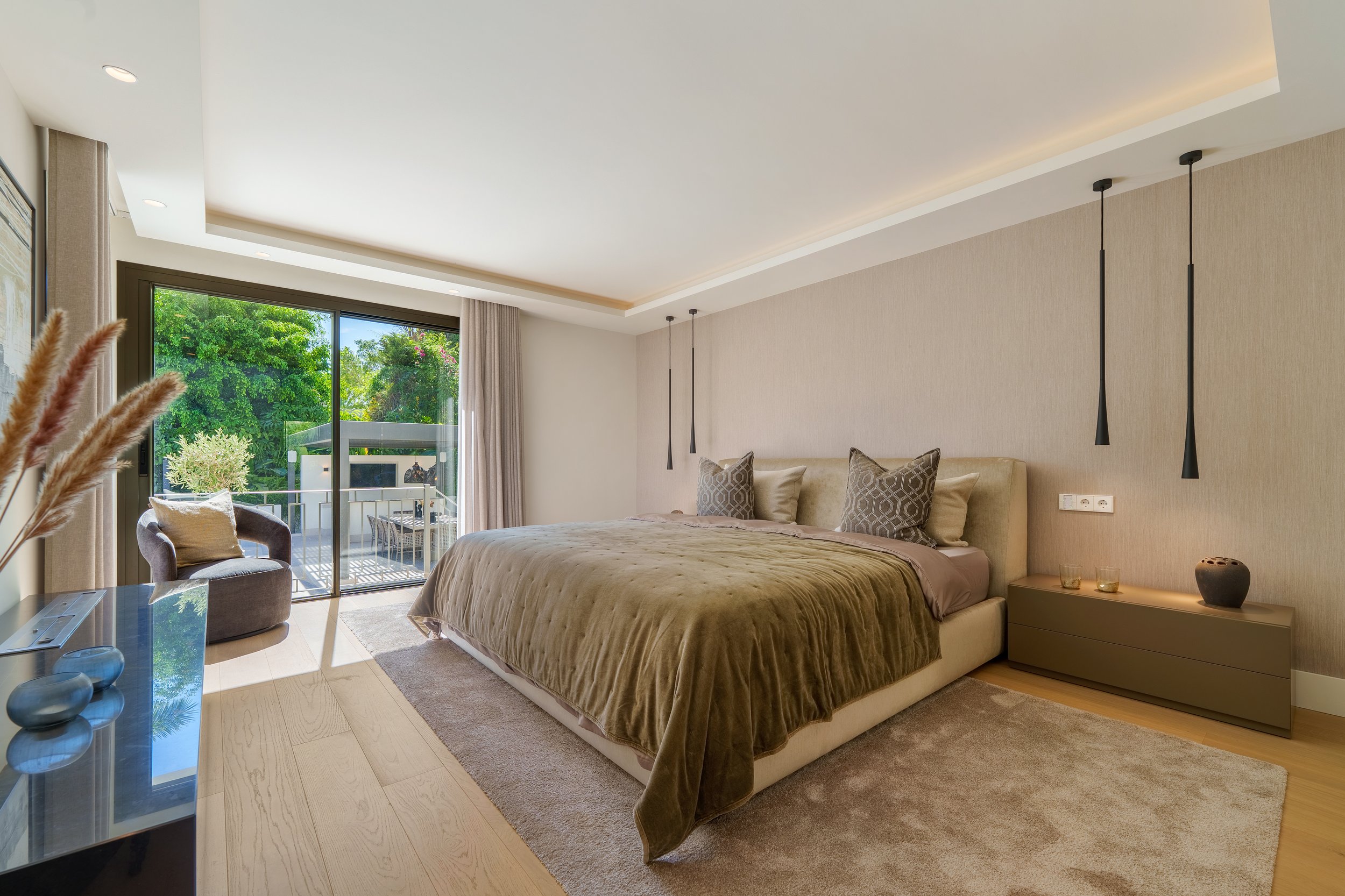 Luxurious master bedroom with private terrace access and Mediterranean views.