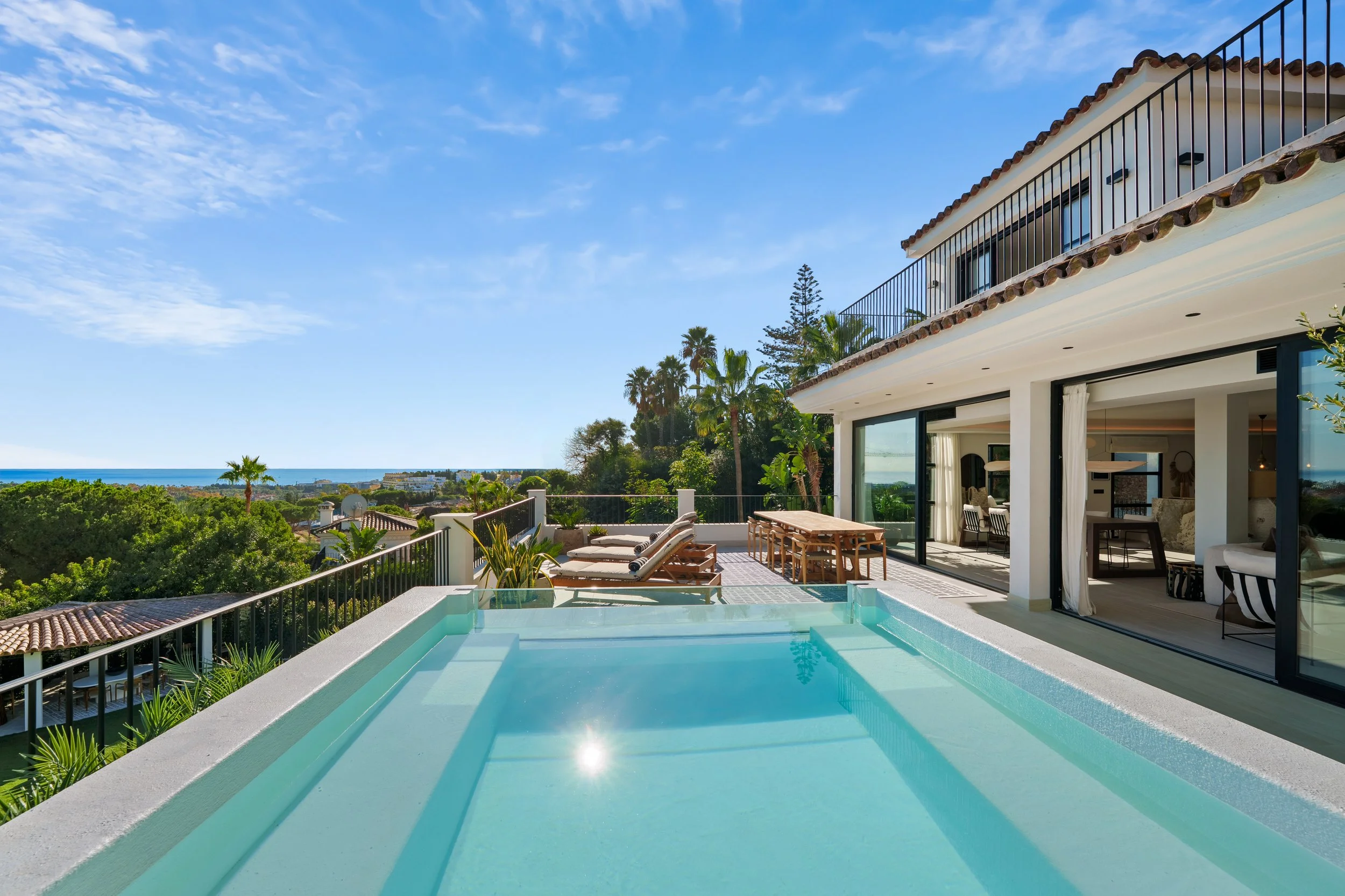 Infinity pool detail showing the glass tile finish and the seamless transition to the golf course views.