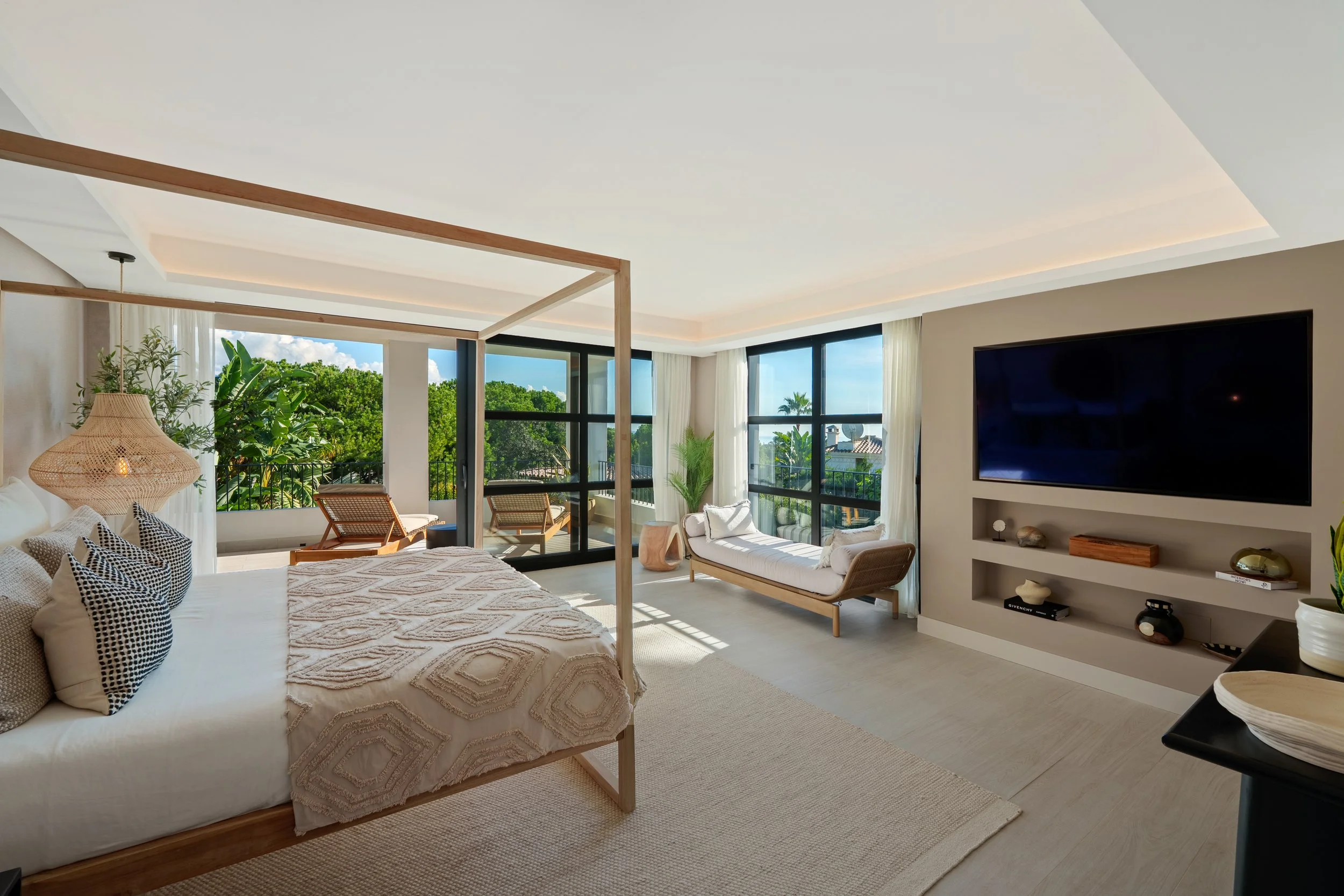 Master bedroom suite with minimalist decor, wooden accents, and a private balcony overlooking the pool.