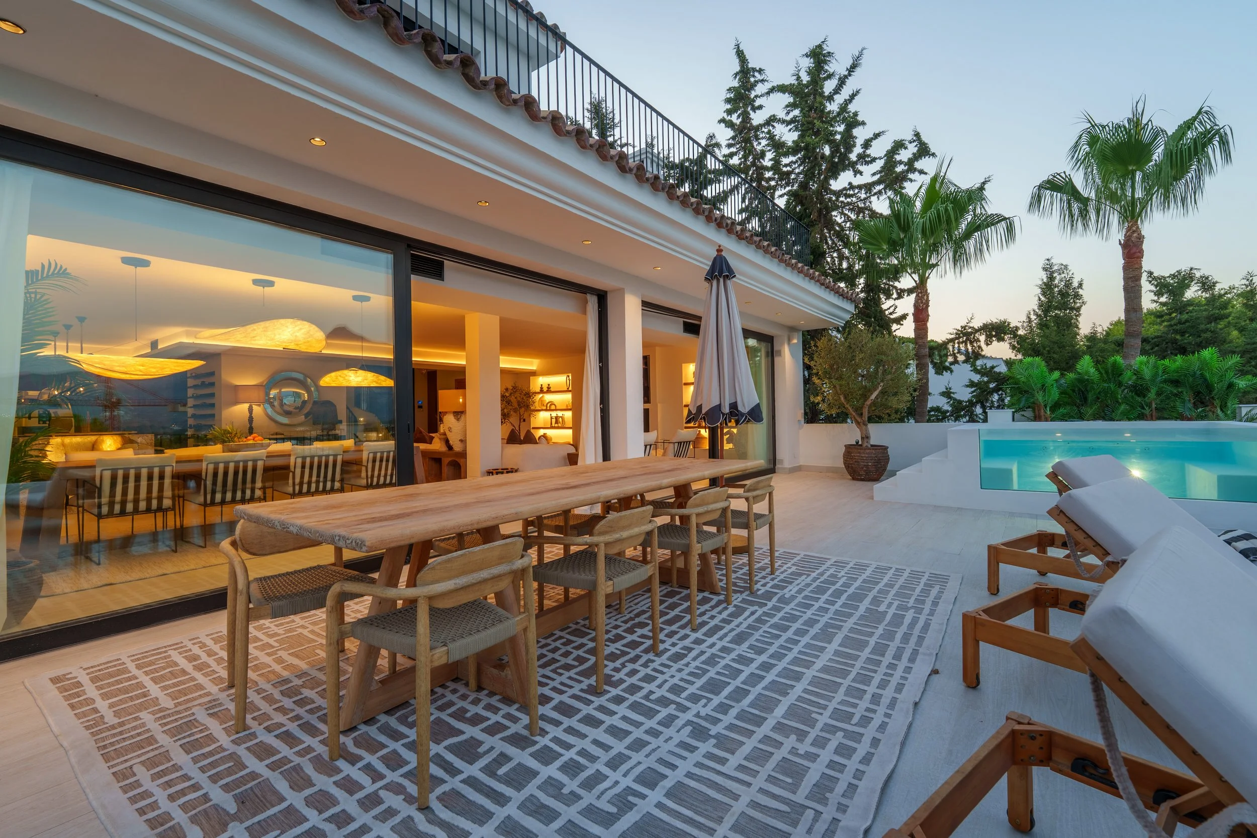 Covered outdoor lounge with contemporary furniture and ambient lighting for evening entertaining.