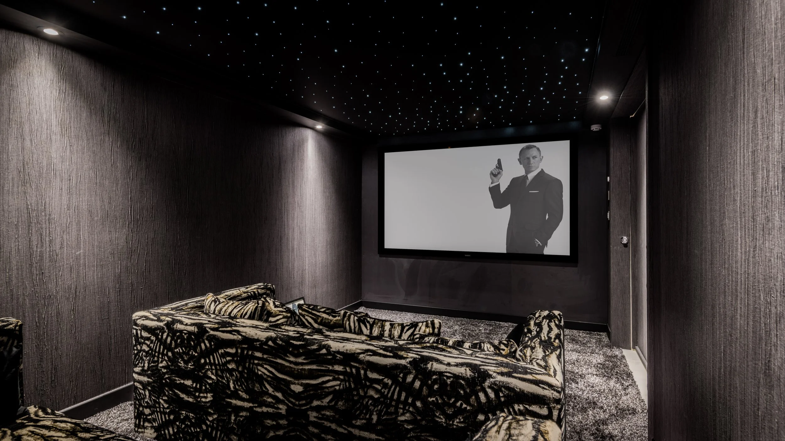 ivate luxury home cinema room in La Cerquilla villa with premium tiered seating large projection screen and ambient lighting Ref CMH2440