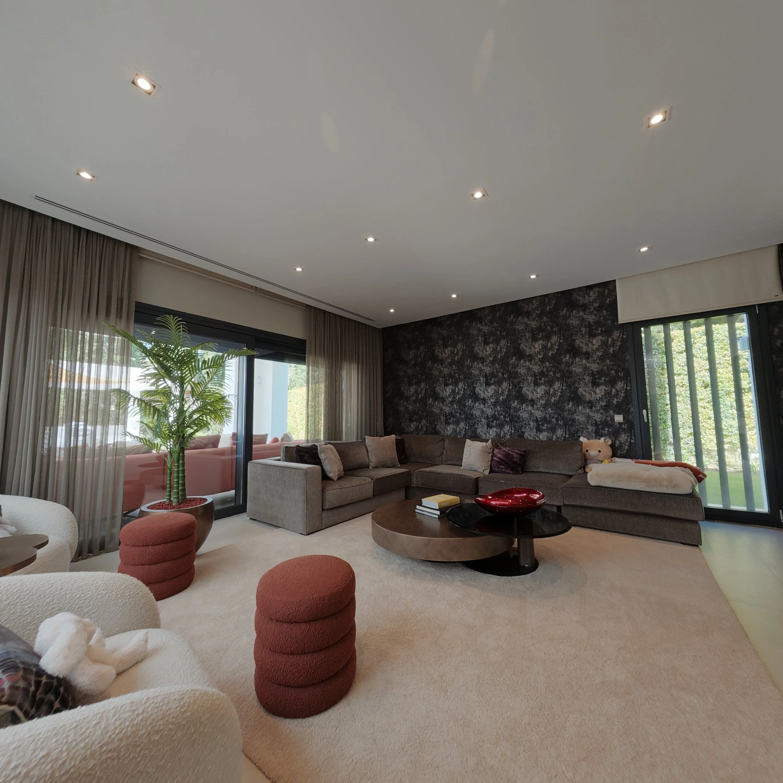 Open-plan designer living room with floor-to-ceiling glass doors.jpg