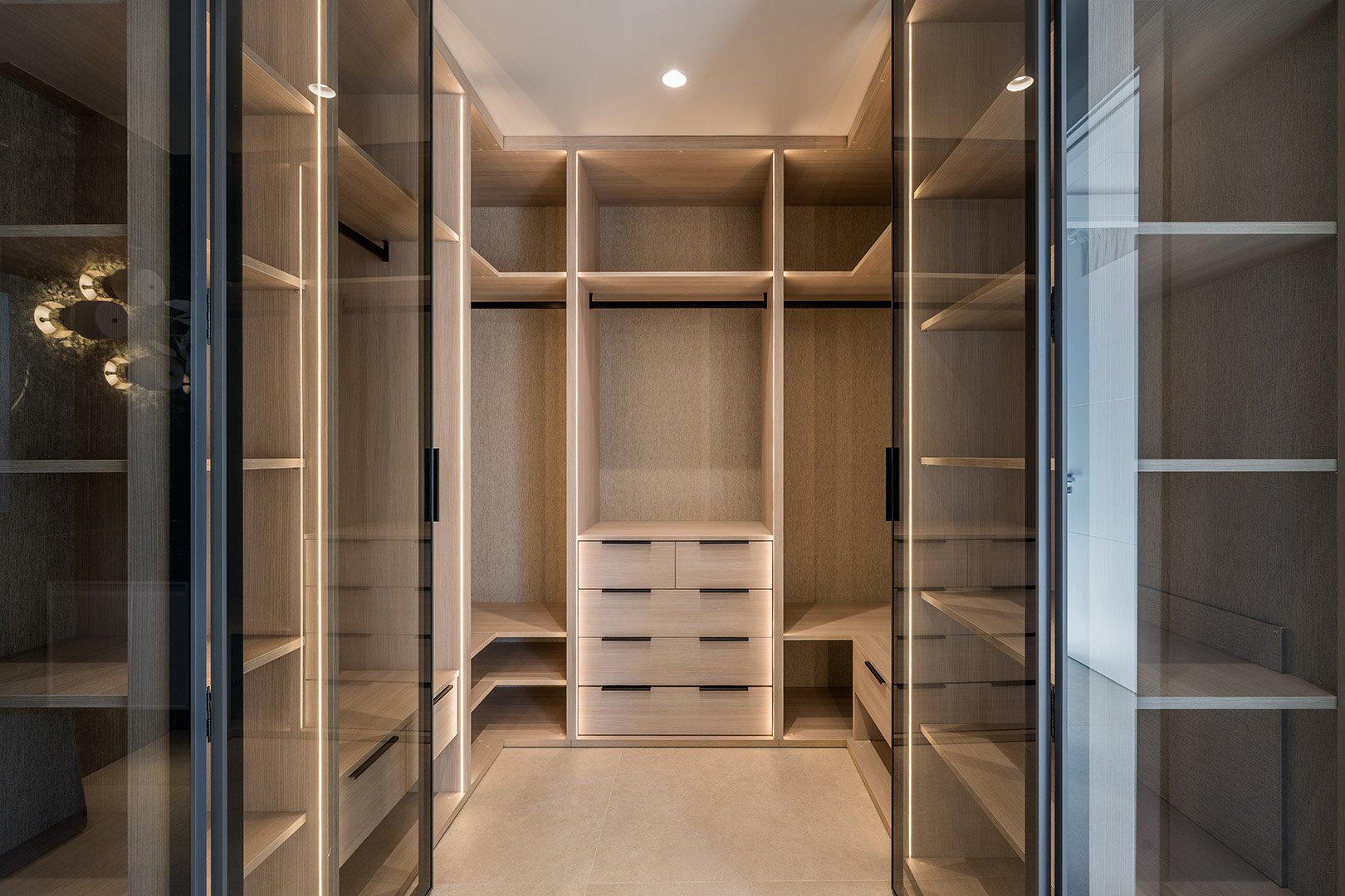 alk-in Wardrobe: Professionally designed dressing area with custom glass-fronted storage and integrated LED lighting for a boutique-hotel feel.