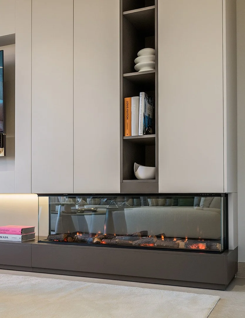 Bespoke Craftsmanship: Custom carpentry and luxury finishes define the interior, including a modern linear fireplace that adds a warm, sophisticated ambiance.