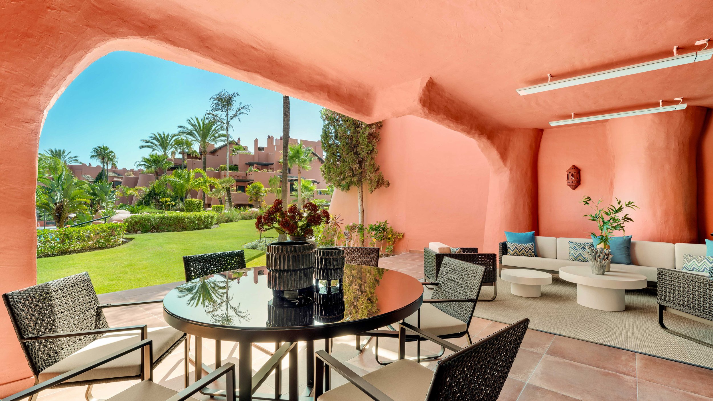 Menara Beach Estepona, frontline beach luxury apartment complex with terracotta architecture and tropical gardens.