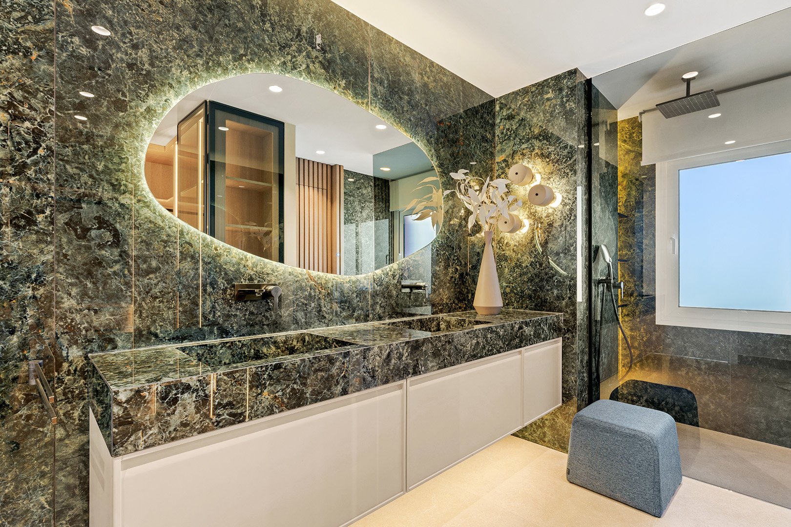 Spa-Inspired Design: The bathrooms feature exotic natural stone, a backlit infinity mirror, and designer fixtures for a true five-star experience.