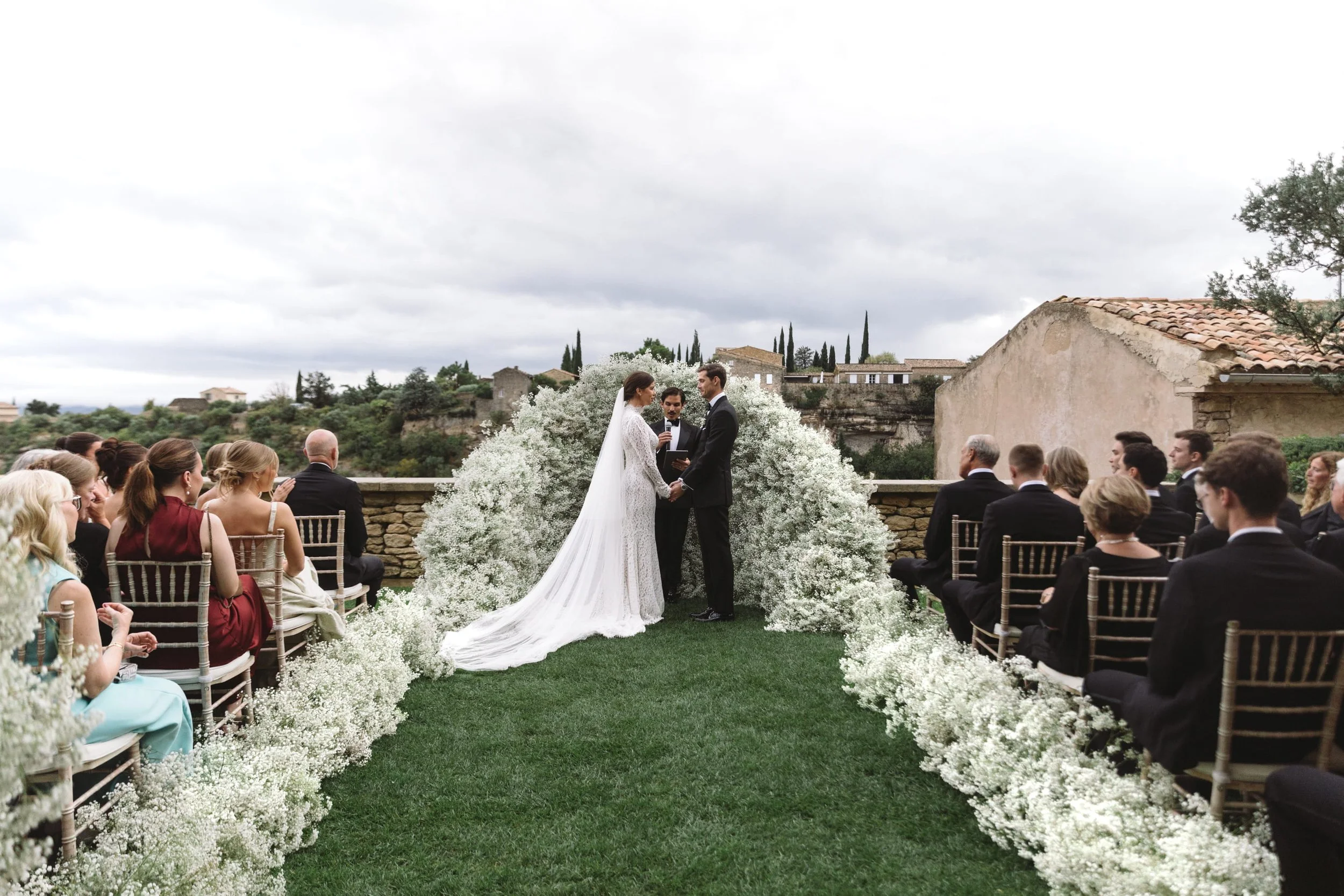 Romantic ceremony with baby's breath wedding arch at Bastide de Gordes South of France