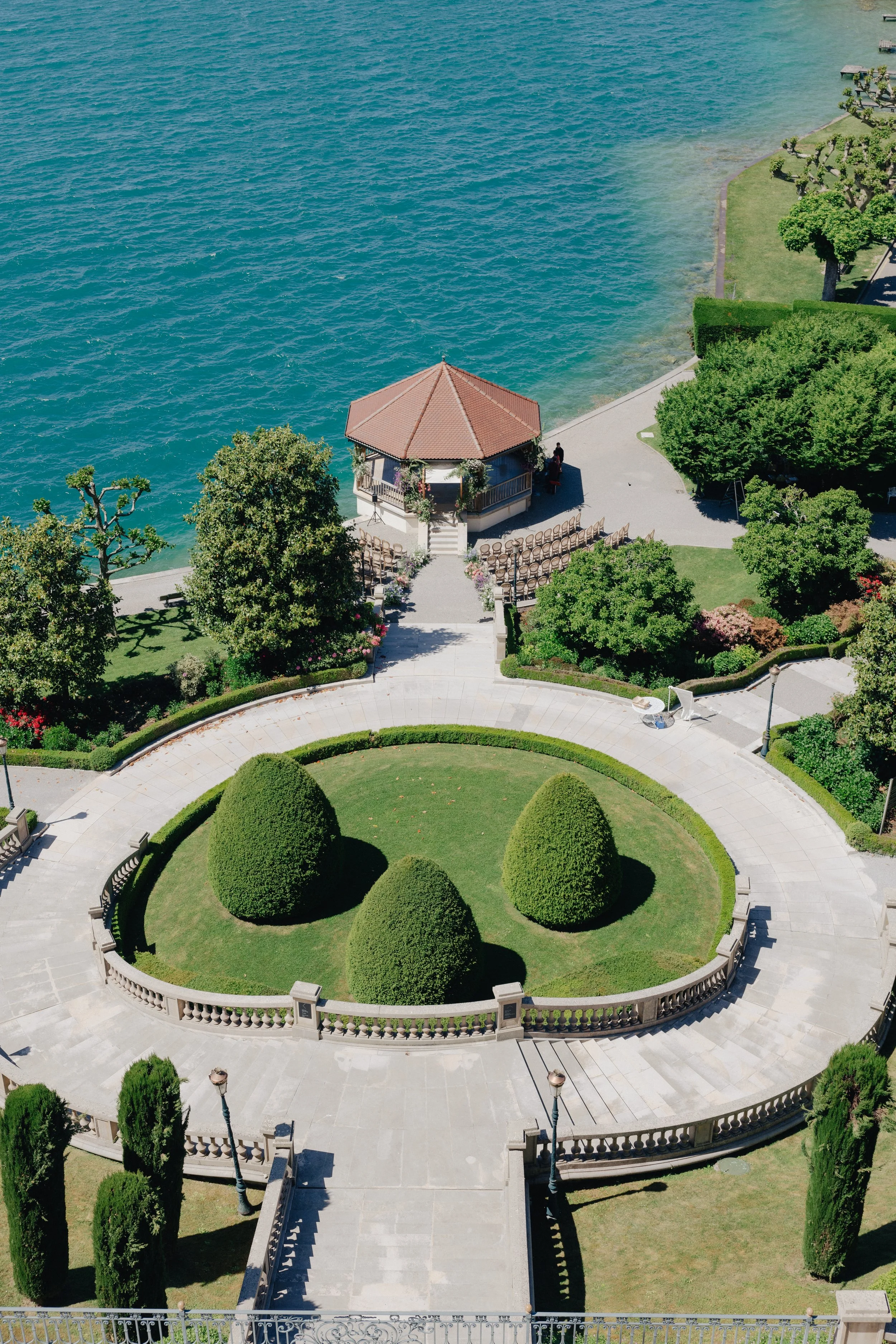 Aerial view of the Palace de Menthon's garden in Annecy, with an outdoor circular ceremony, facing the lake of Annecy.