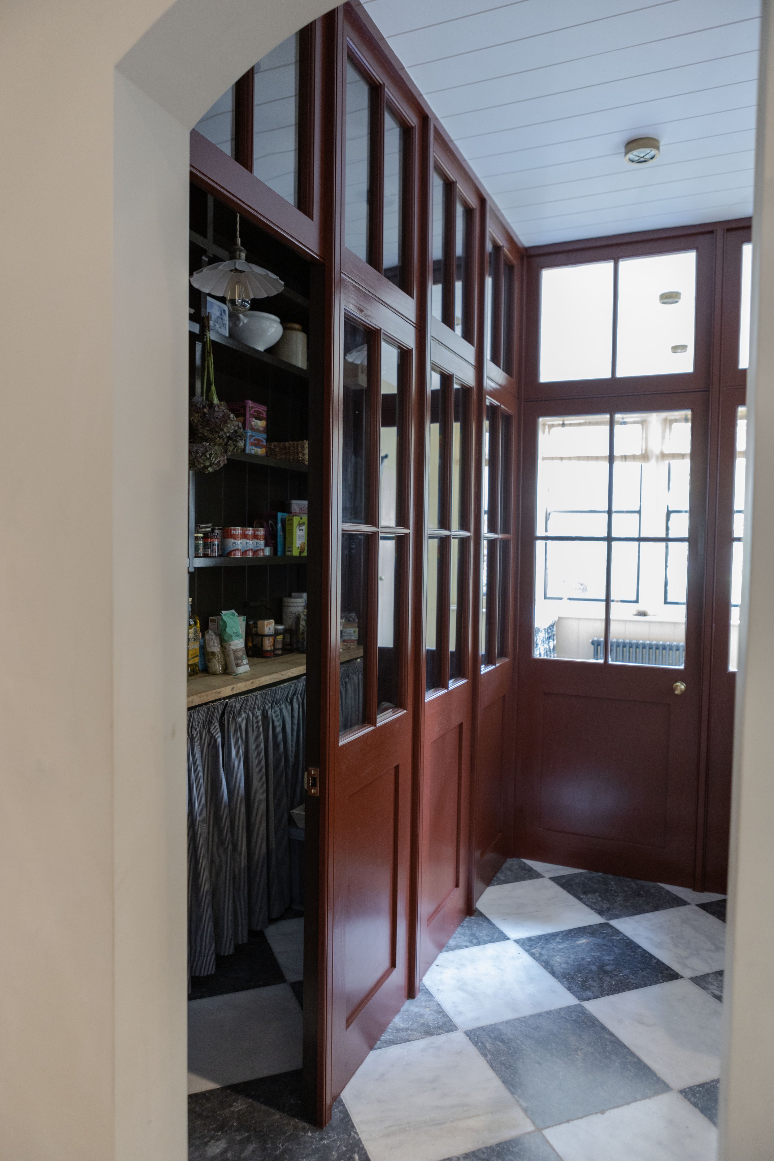 The kitchen and pantry were inspired by “old shops” a butcher’s, a haberdashery in the kitchen with ceiling height tiling and large drawers, a sweetshop in the glazed pantry. It creates a playful yet classic feel and is also very practical as the dif