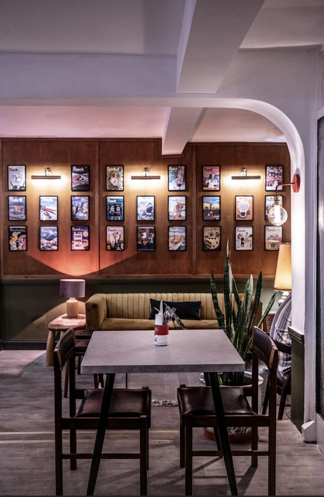 We wanted to feature a wall of the owner’s vintage Punch magazine covers with picture lighting for a playful nod to the past. 