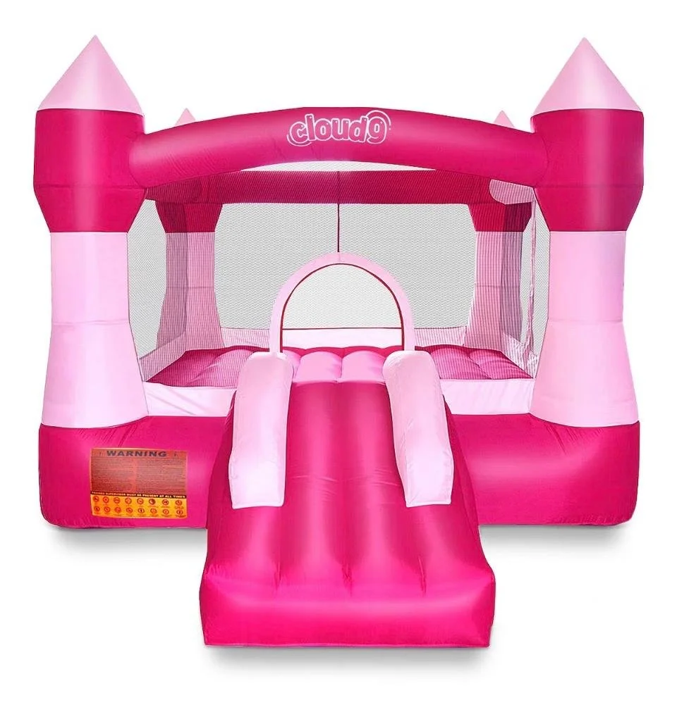 Pink inflatable bounce house with a slide, castle-like towers, and mesh sides.