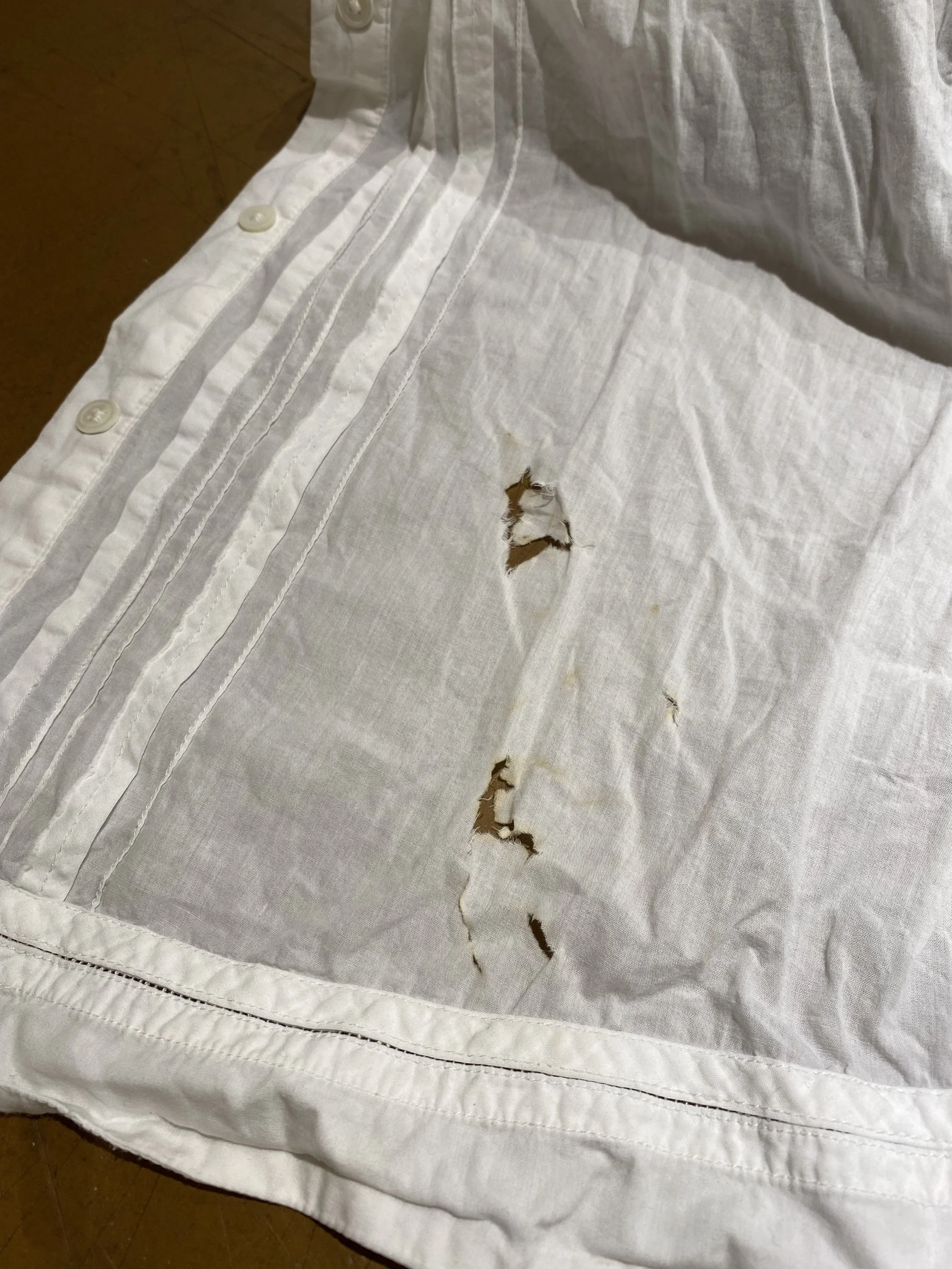 Burn damage on white cotton blouse