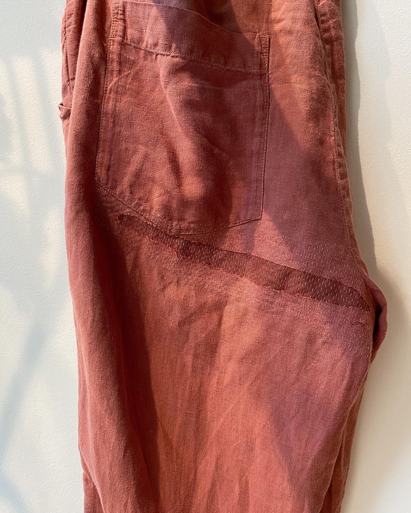 Discreet repair on seat of linen trousers, close colour match fabric on reverse and sashiko style stitching in matching thread