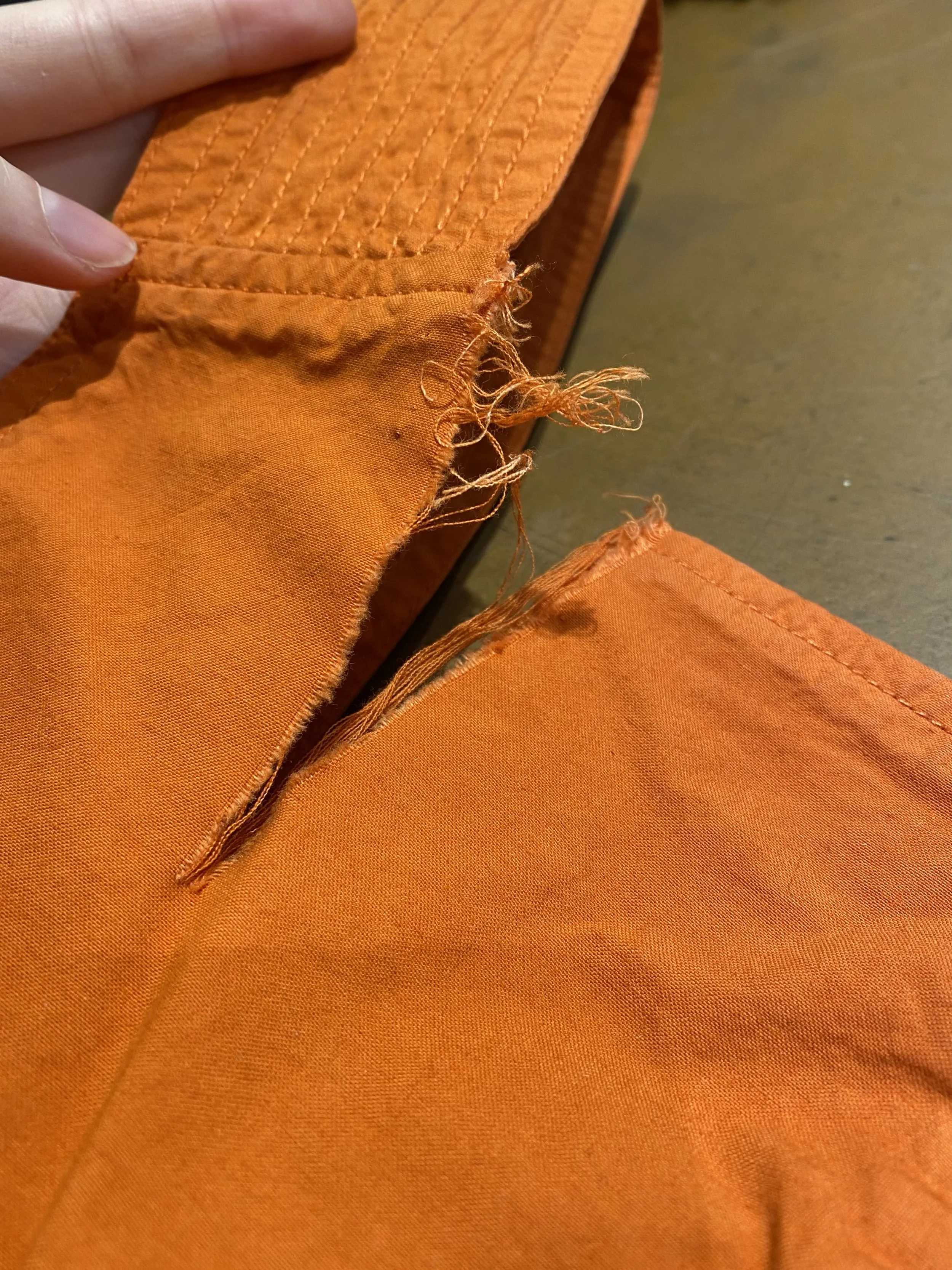 Tear in cotton jumpsuit by strap