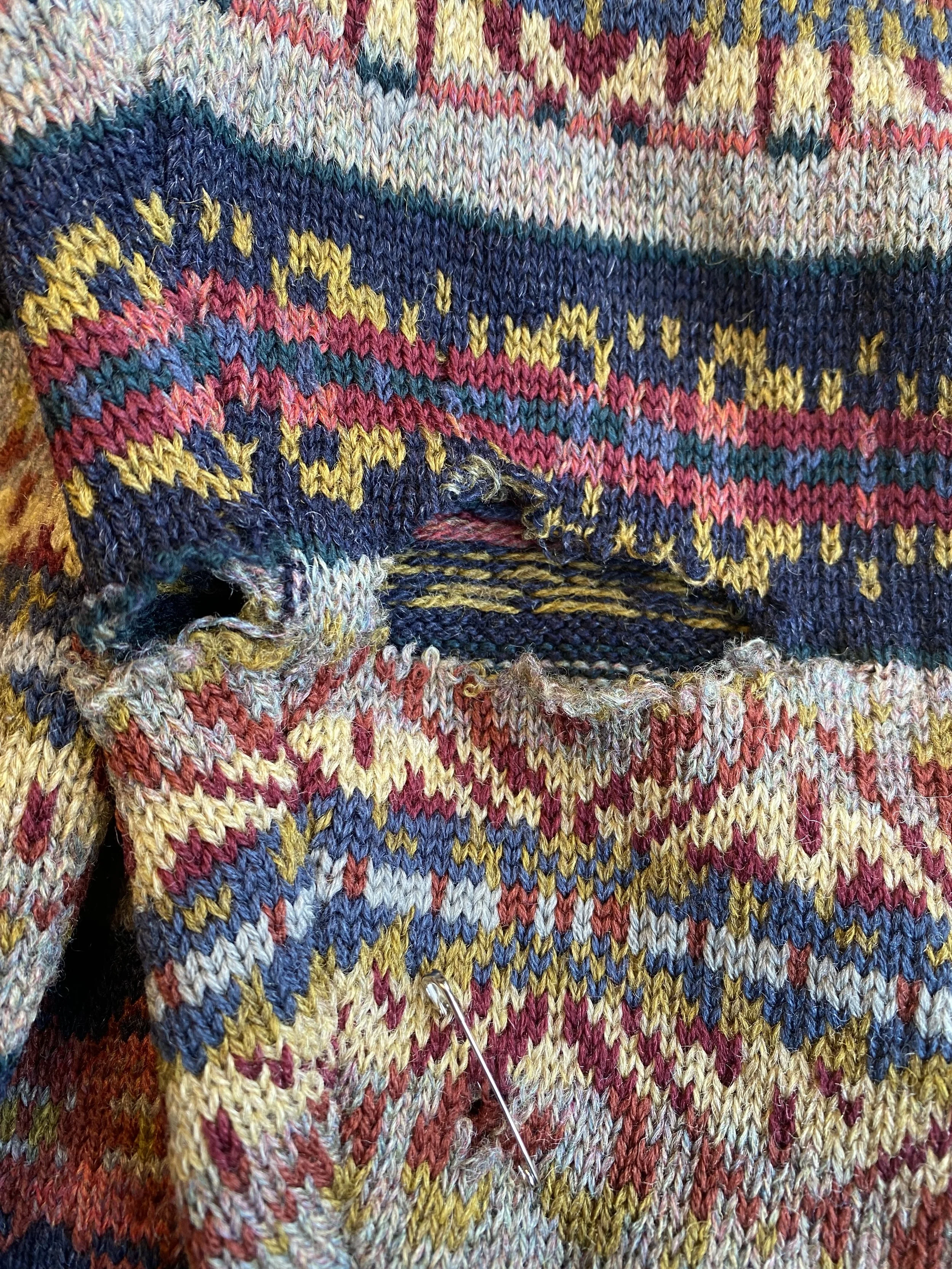 Before image of multiple holes in sleeve of fairisle cardigan