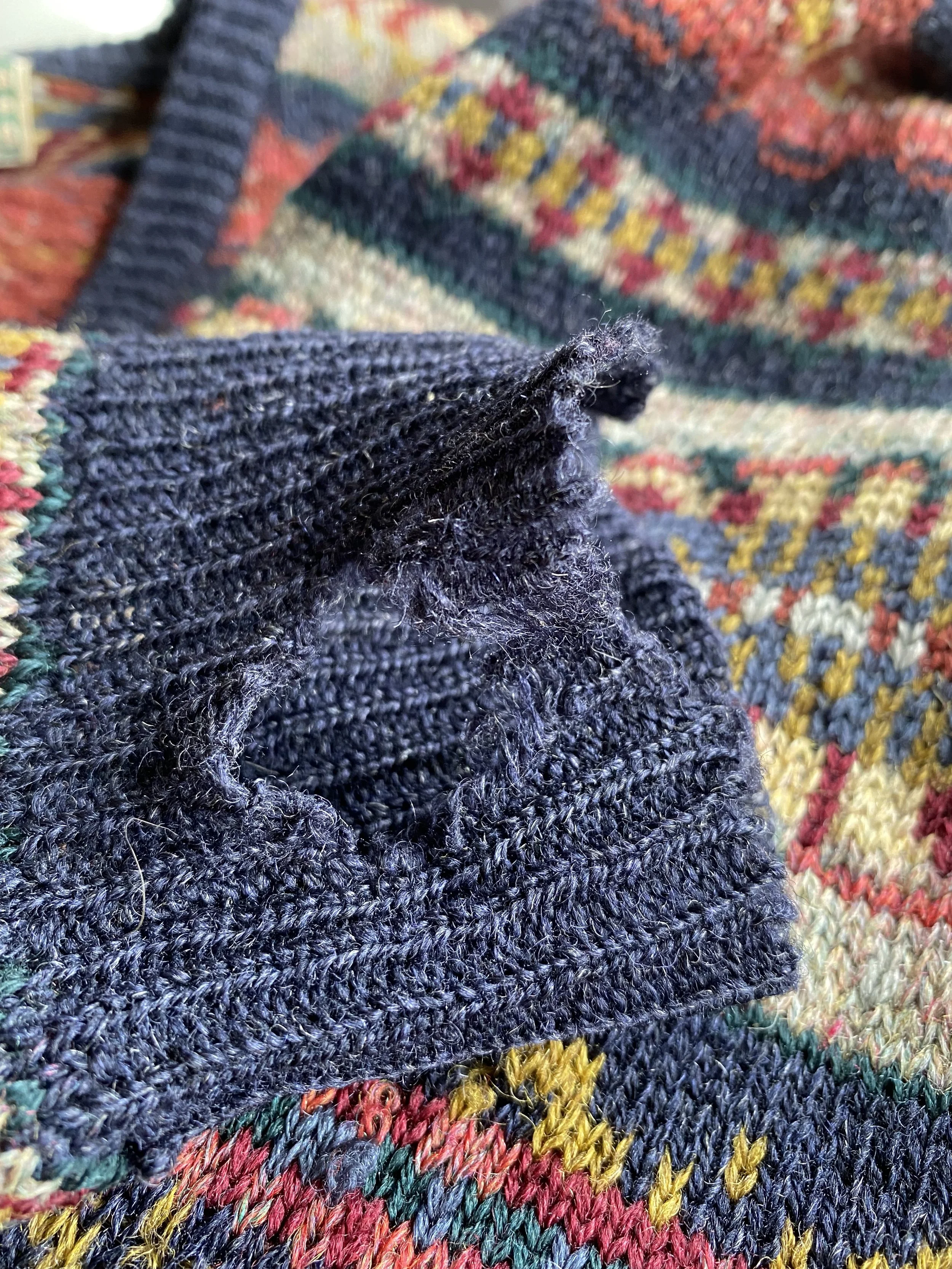 Before picture of damaged knitted cuff of fair isle cardigan