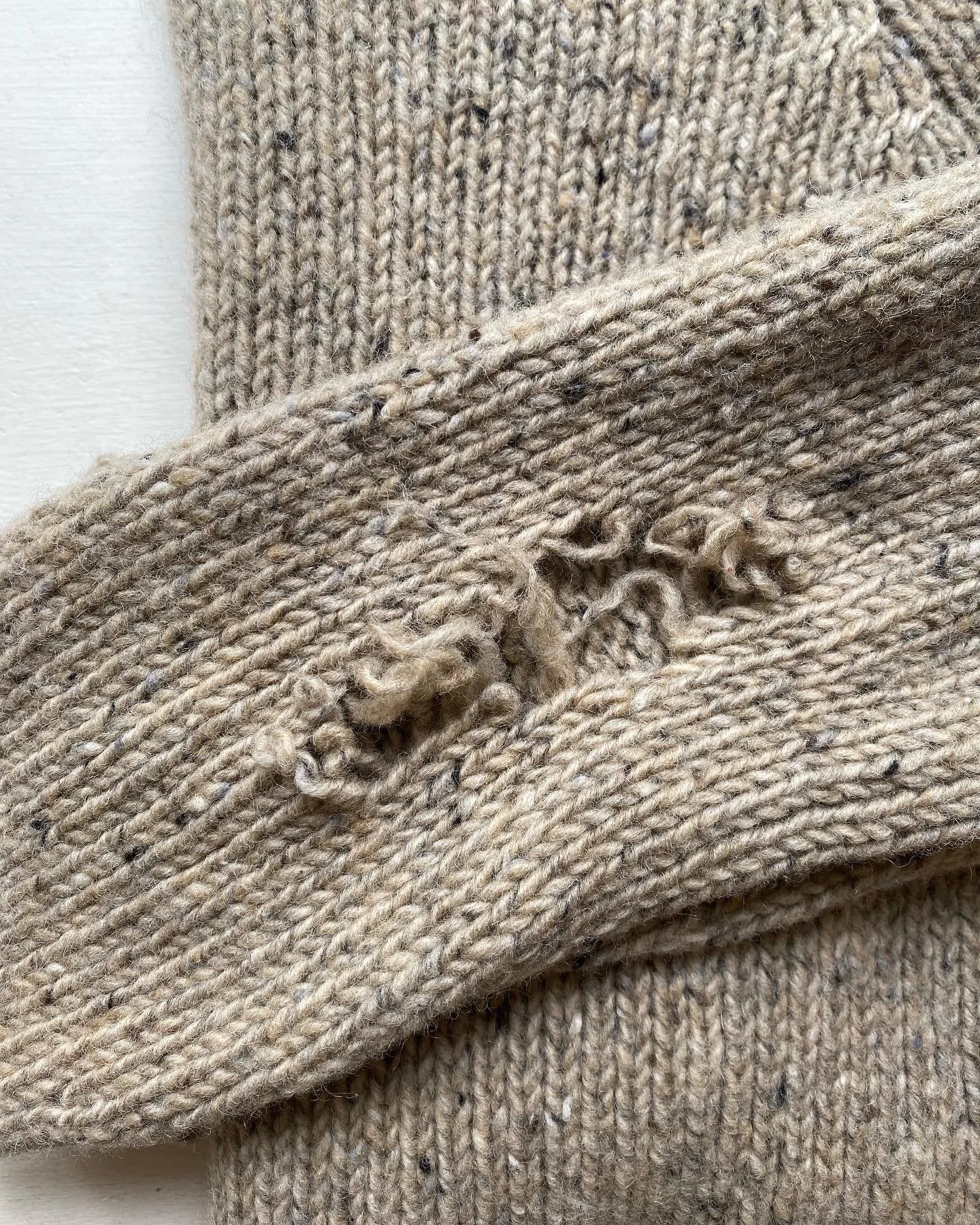 Elbow hole needing repair on knitted jumper