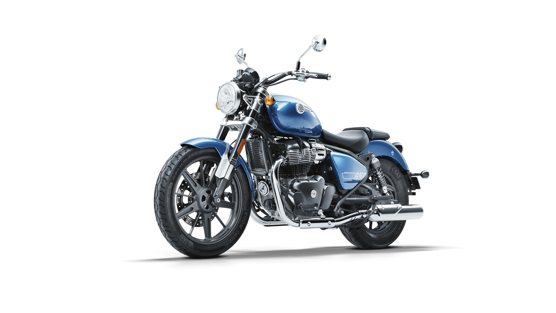 Blue cruiser motorcycle with black seat and chrome exhaust pipe on a black background.