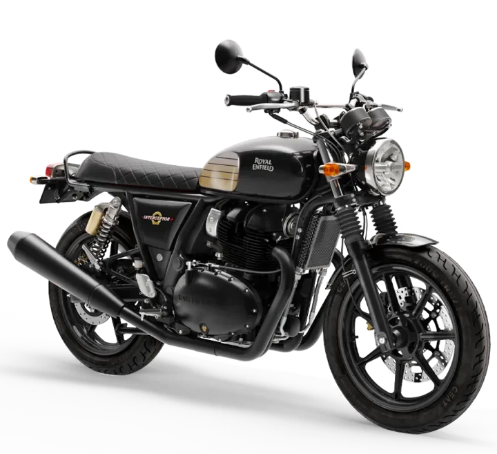 Black vintage-style Royal Enfield motorcycle with a quilted seat, front headlight, and dual rear shock absorbers.