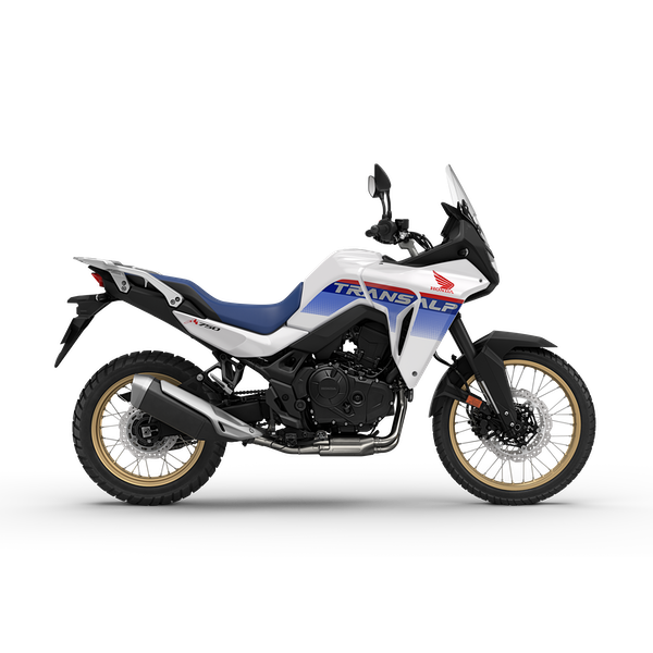 A white Honda adventure motorcycle with blue and red accents, featuring the Transalp logo on the side, gold-colored wheels, and a tall windshield.