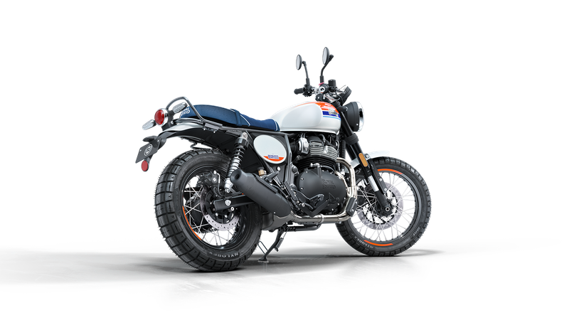 A white and black modern motorcycle with blue, red, and white stripes on the gas tank, black exhaust pipe, and wire-spoked wheels.