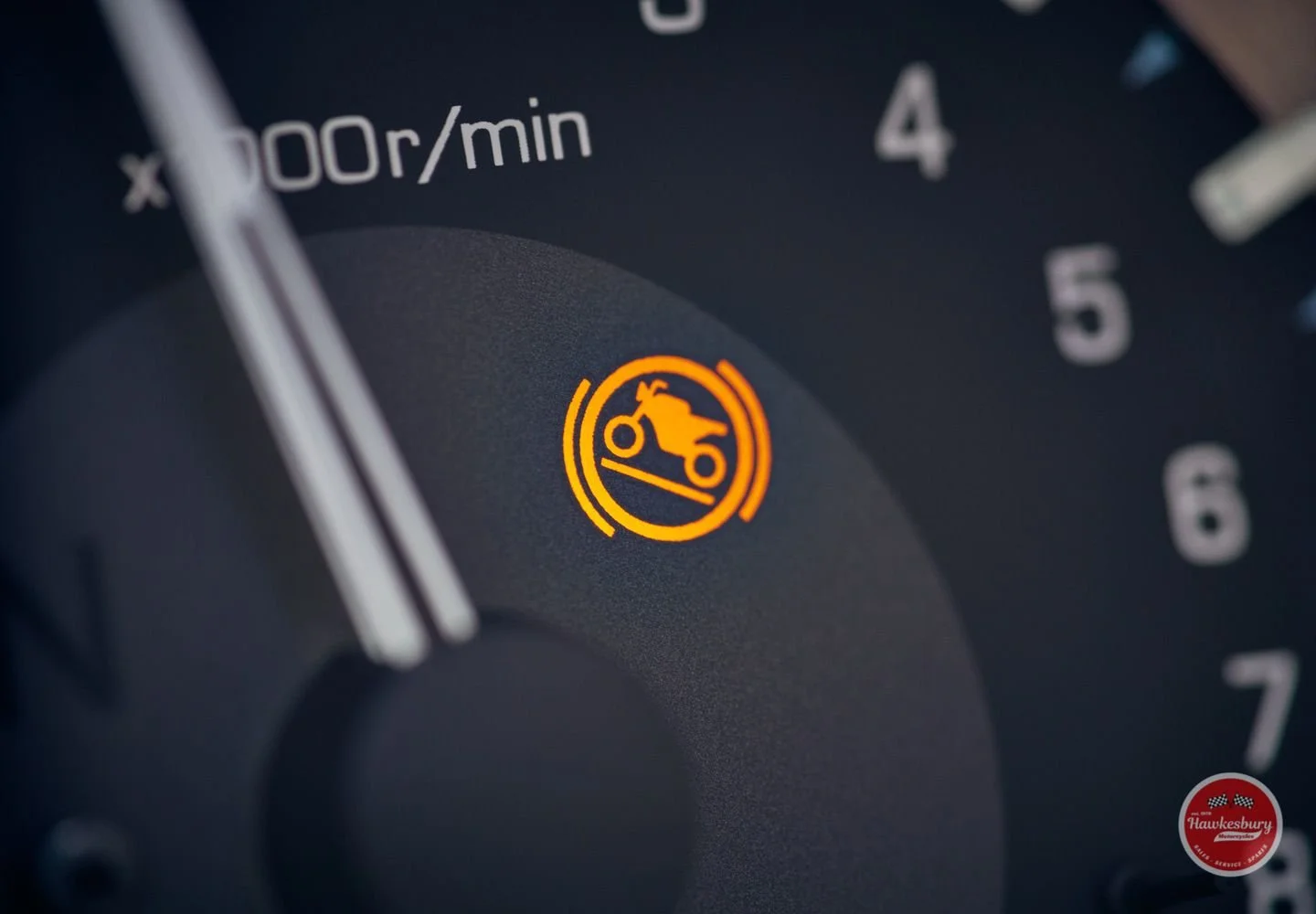 Close-up of a car dashboard showing a yellow warning light for the oil pressure issue.