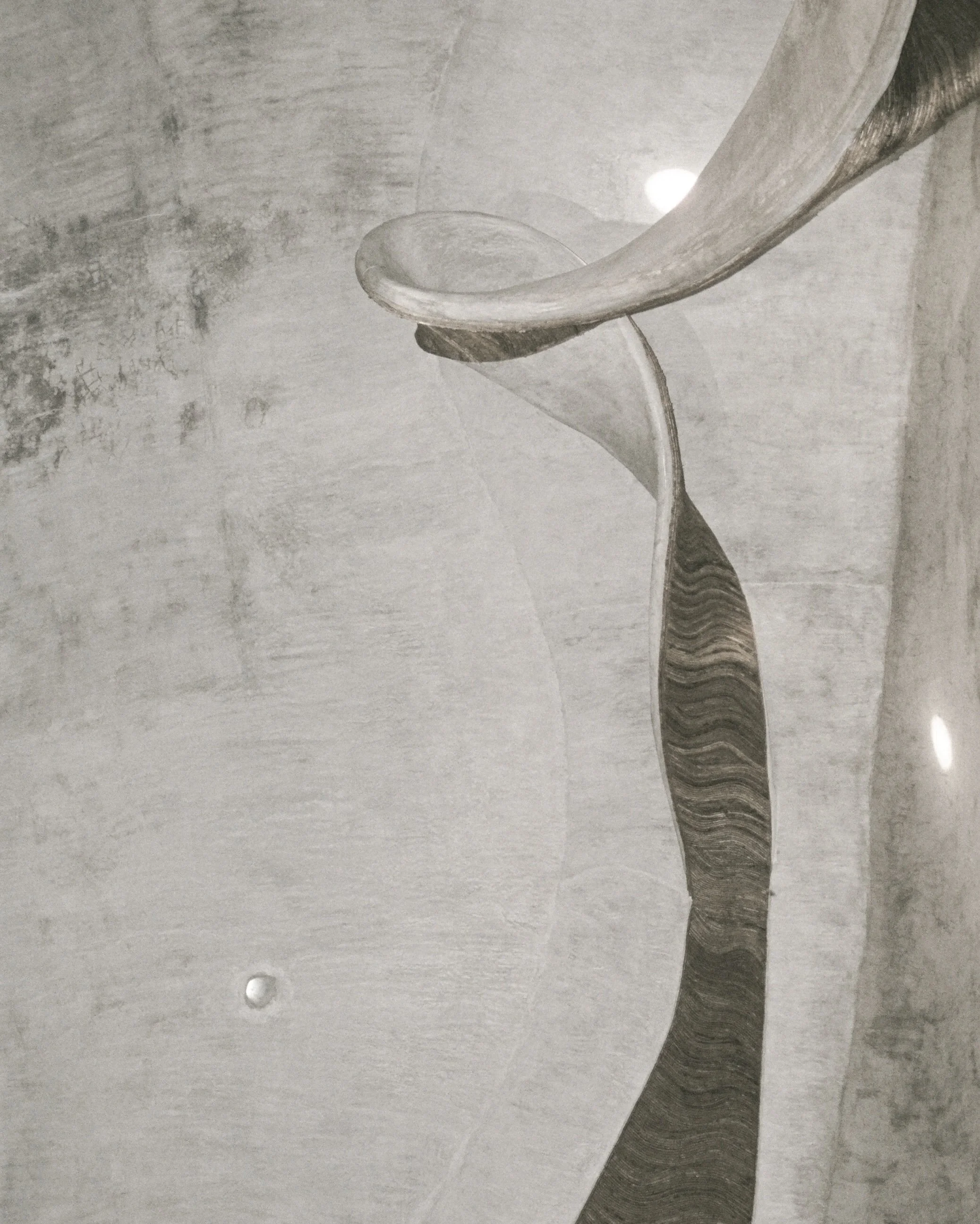 Marble sculpture with abstract flowing shapes and curved lines