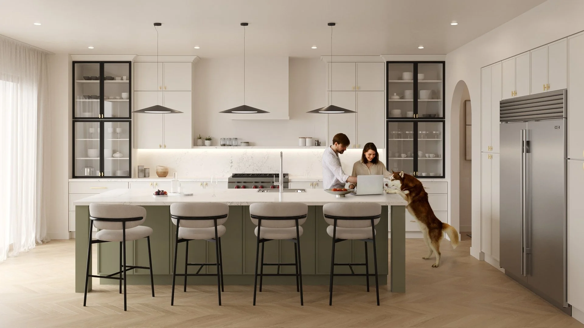 A modern kitchen with white cabinets, open shelving, and a central island with four barstools. A man and woman are standing at the island, smiling and looking at a laptop. A dog is interacting with the woman near the counter. The kitchen has stainless steel appliances, pendant lighting, and natural light coming from a large window with sheer curtains.